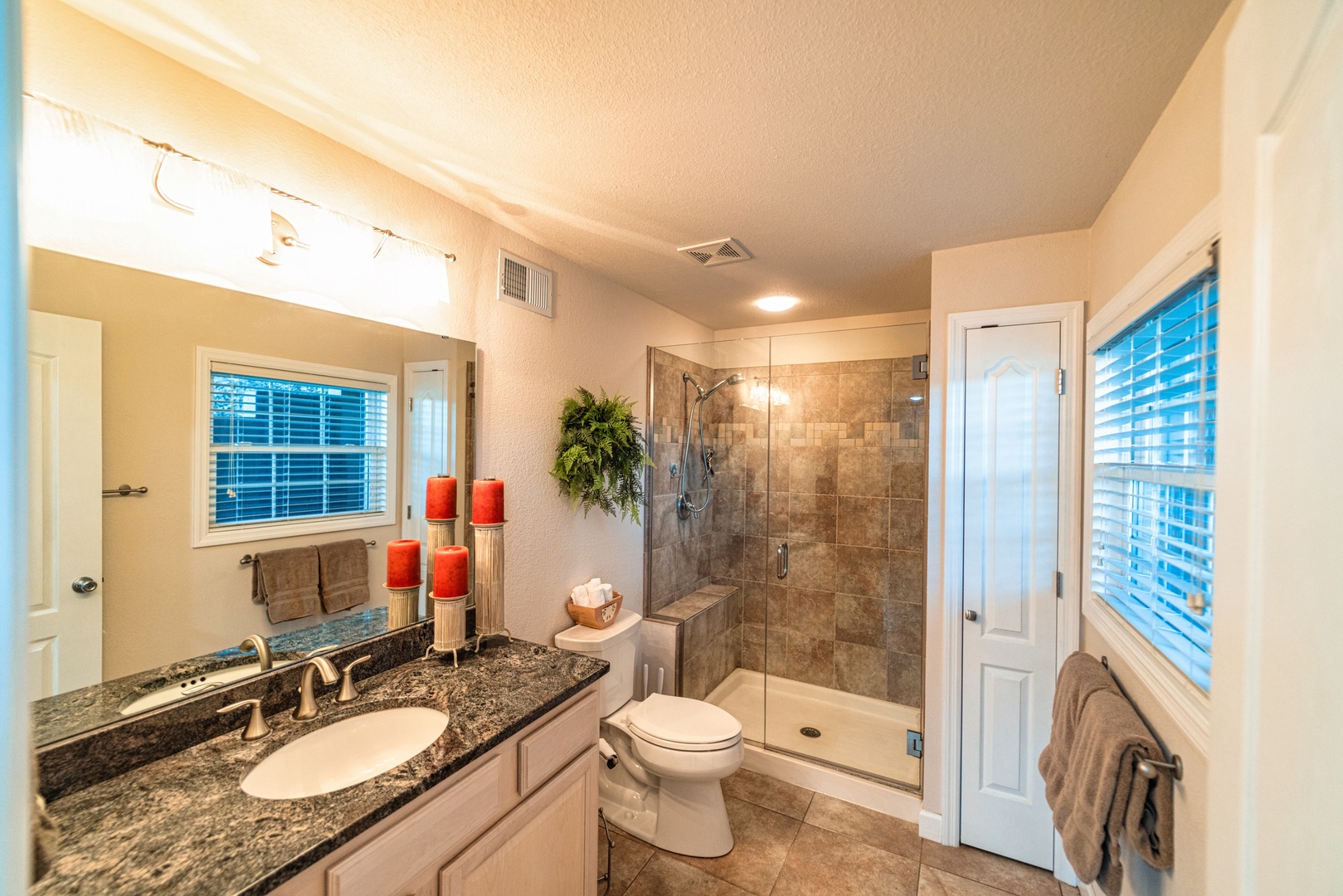 The lower-level full bath includes a single vanity & glass shower