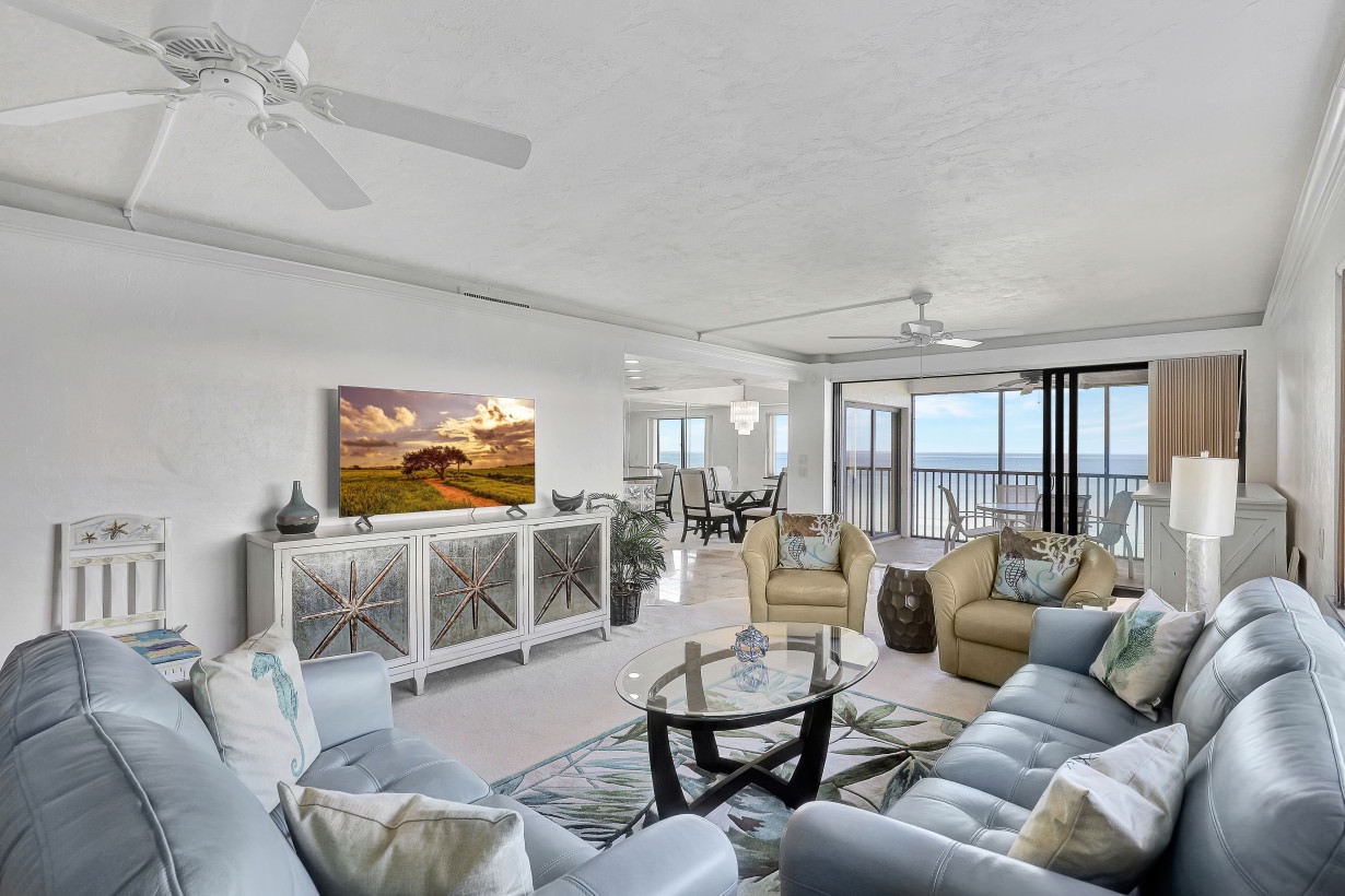 Open living space with Ocean View, balcony, and TV
