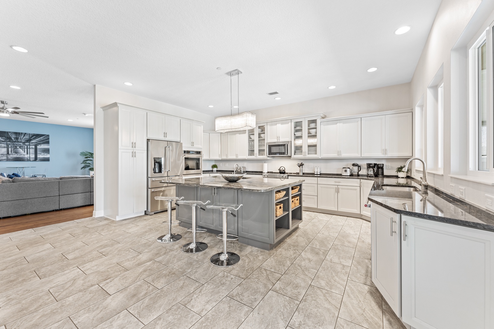 Fully equipped kitchen with counter seating and covered deck