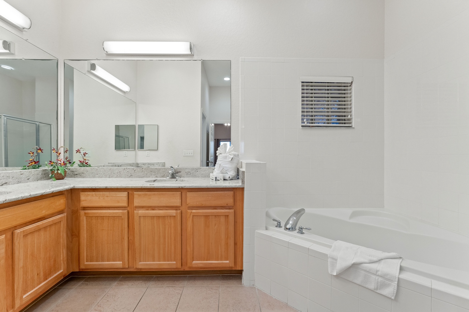 A double vanity, shower, & tub await in the ensuite bath