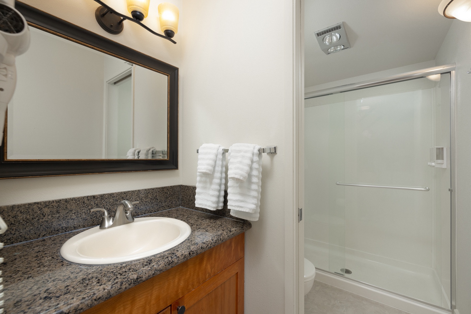 The main bathroom includes a single vanity sink & walk-in shower