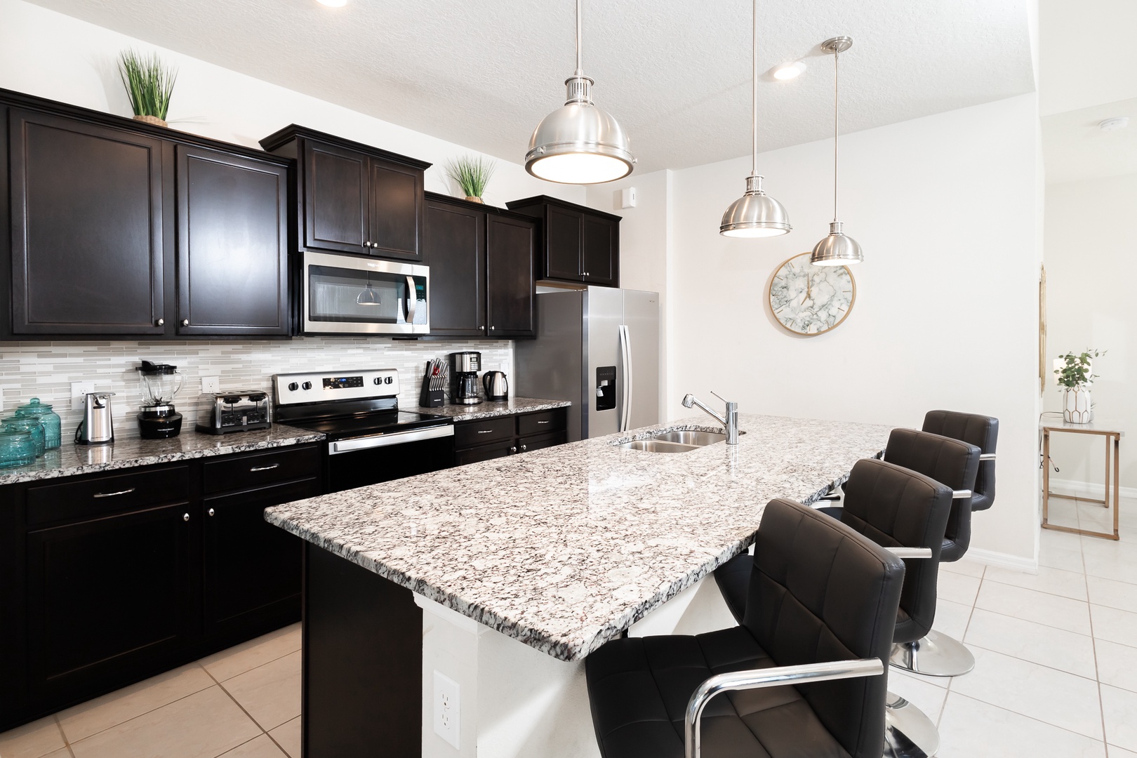 The chic, updated kitchen is well equipped with all the comforts of home