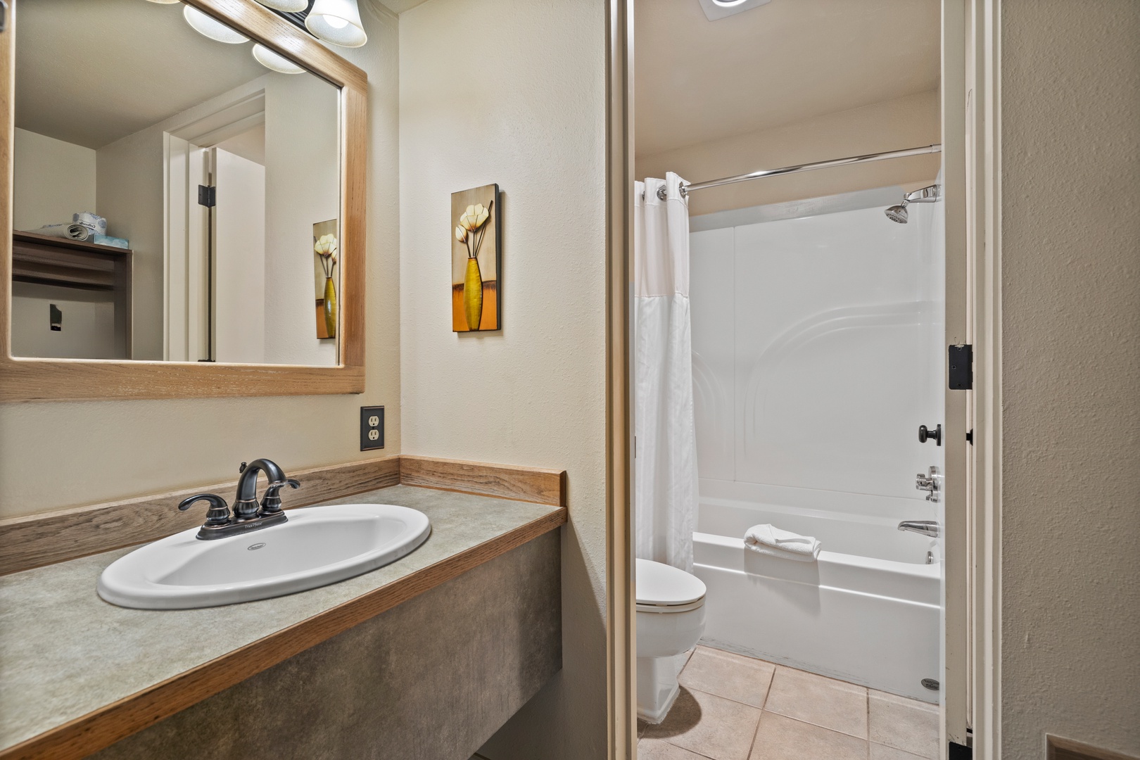 A second full bathroom offers a single vanity & shower/tub combo
