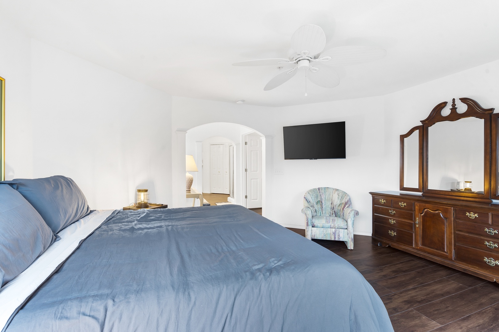 The primary king suite boasts a private ensuite, Smart TV, & balcony access