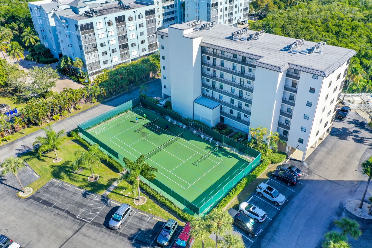 Aerial view of complex with tennis court