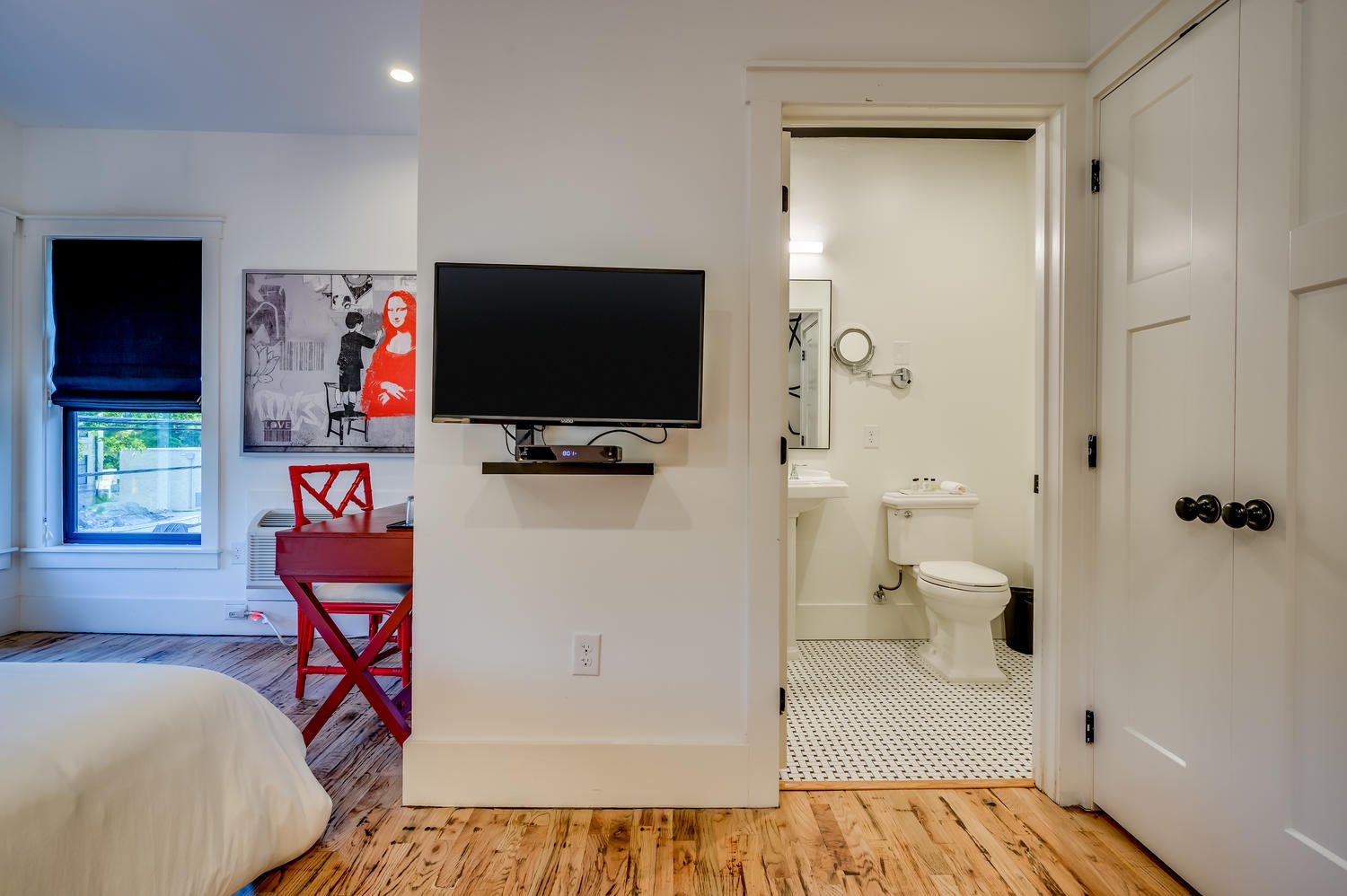 Suite 201 – The 2nd Floor Red, White & Black Suite boasts a Casper Queen Bed, Smart TV, and En Suite Bathroom