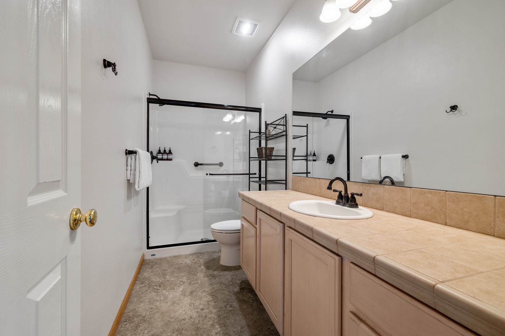 This 2nd floor bathroom offers a large single vanity & glass shower
