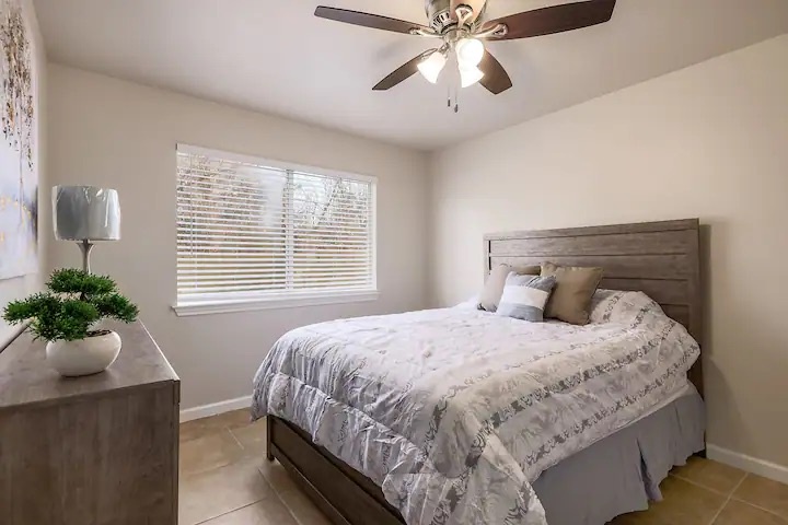 The 2nd of 2 additional queen bedrooms, offering a large dresser & ceiling fan
