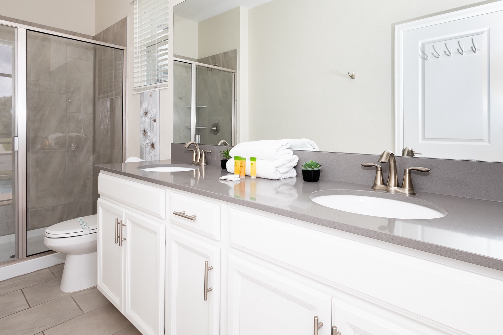 Wash up in this king ensuite, featuring a double vanity & glass shower