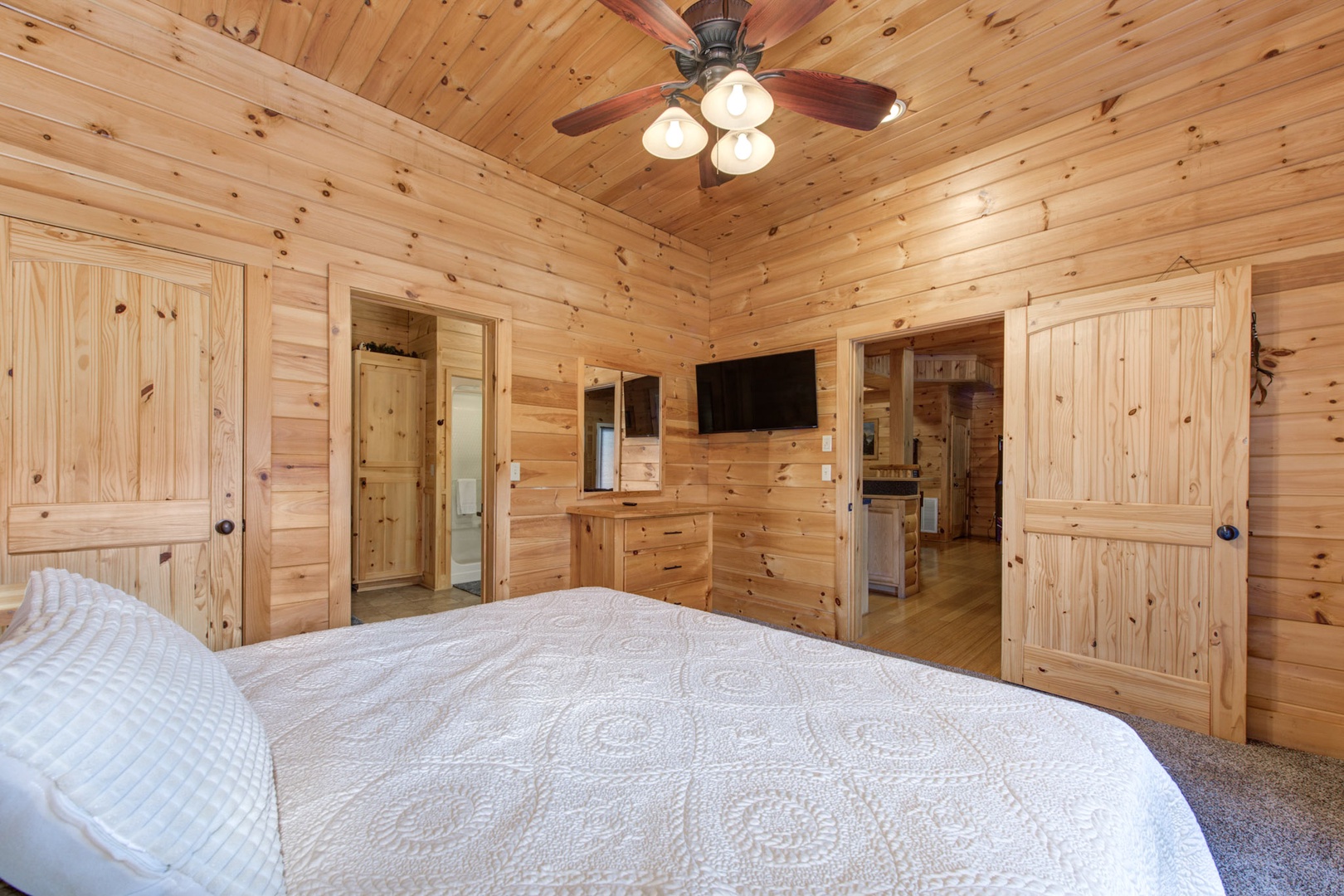 The final lower-level suite boasts a cozy king bed, ensuite bath, & Smart TV