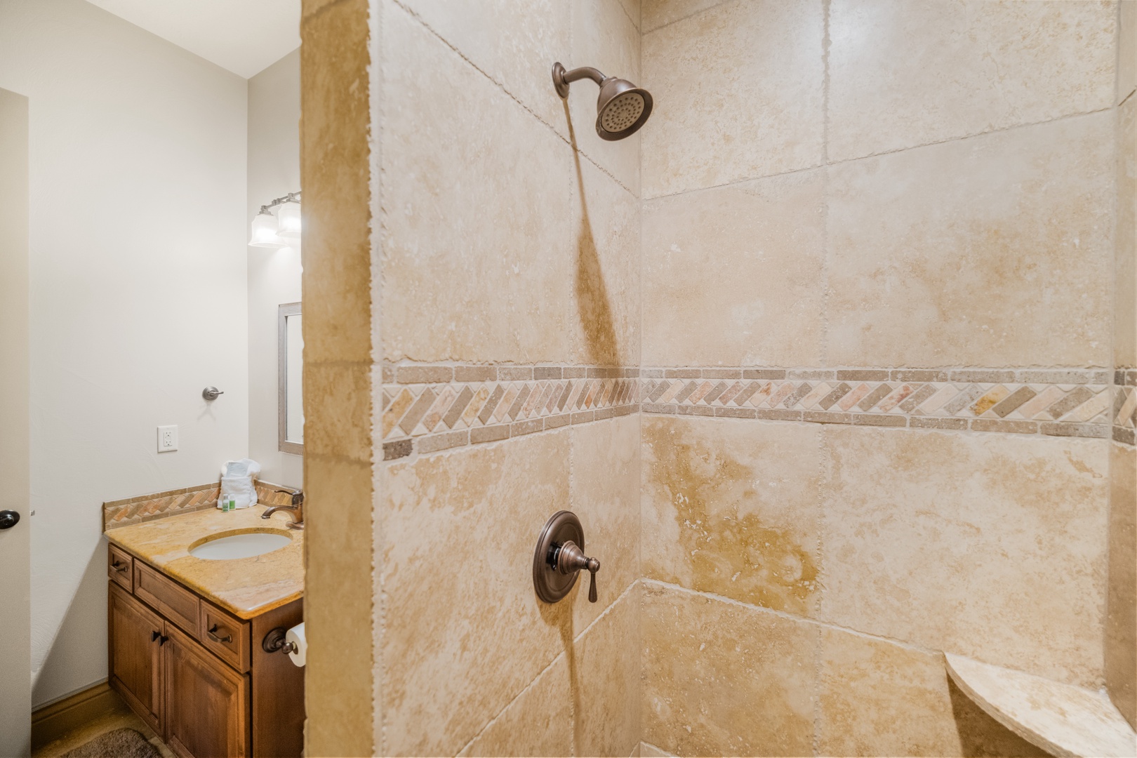 The full shared bathroom includes a single vanity & walk-in shower