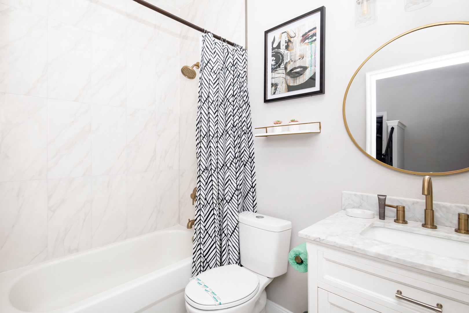 Shared bathroom with single vanity and  shower/tub combo