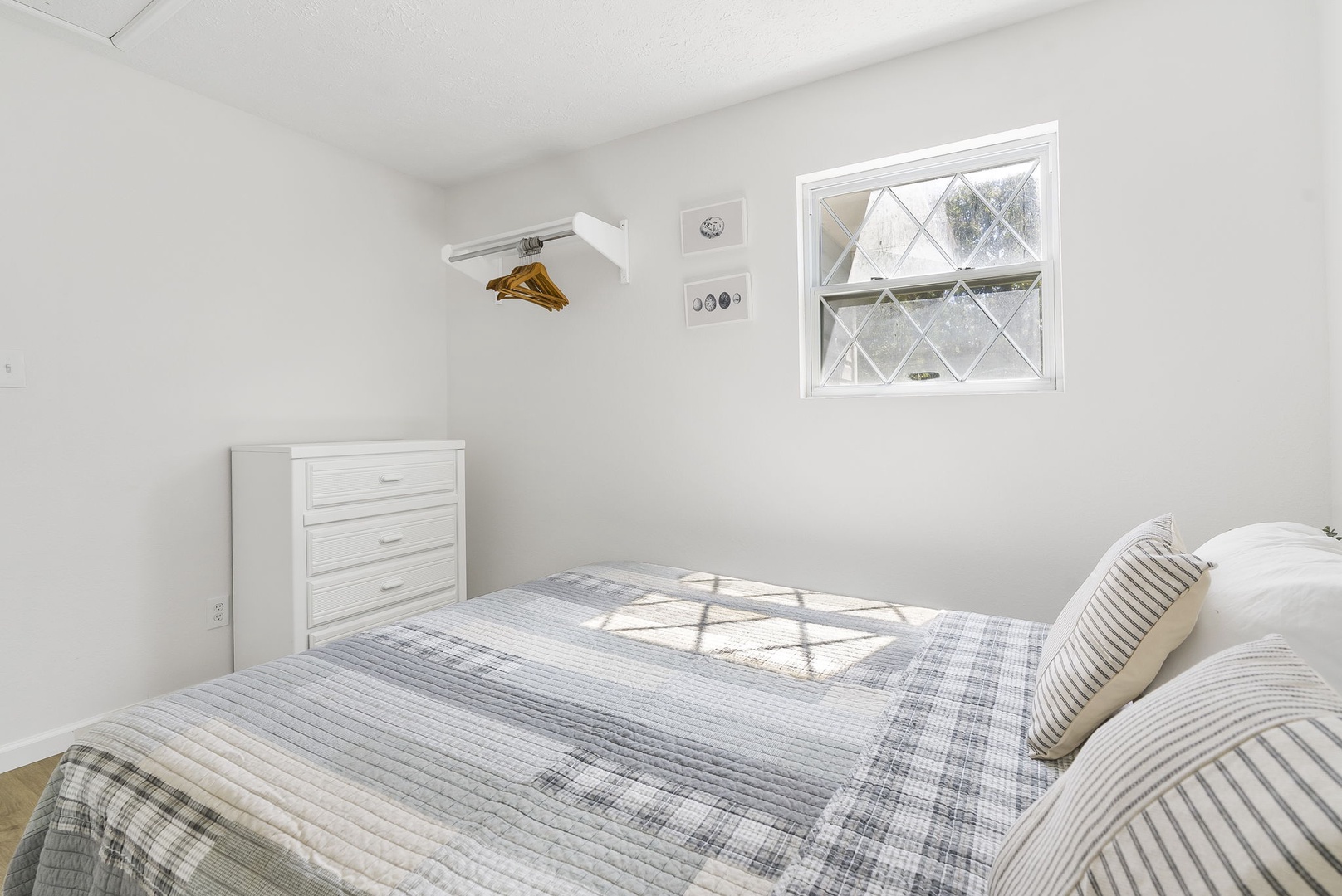The 1st of 3 bedrooms on the second floor offers a queen bed