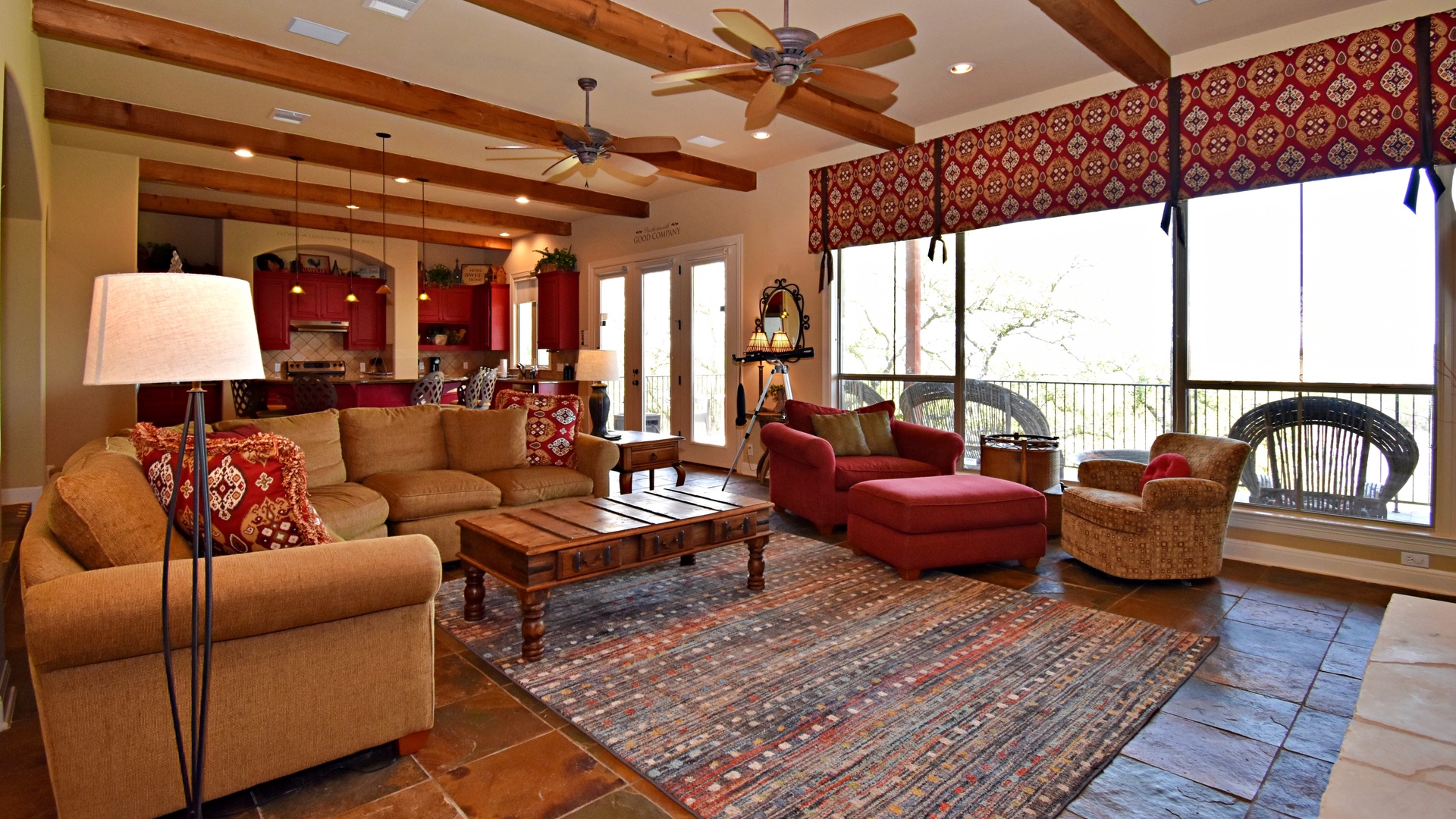 Open living space with lake view, TV, fireplace, and deck access