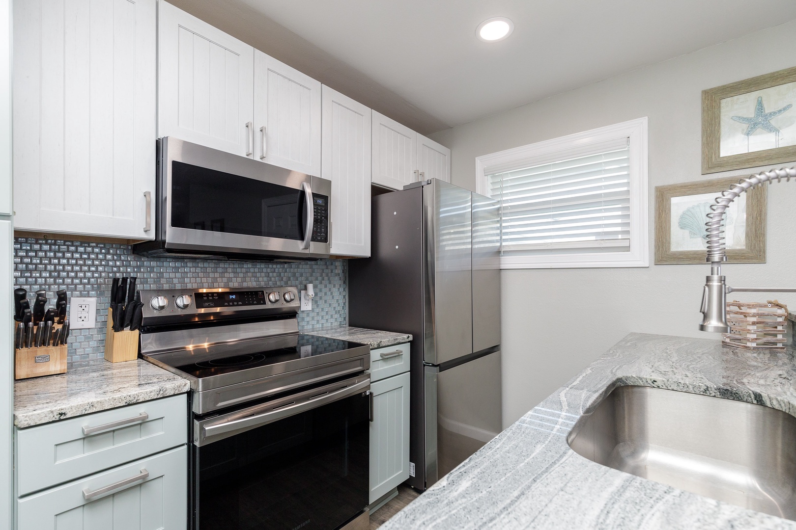 The updated, beachy kitchen offers ample space & all the comforts of home
