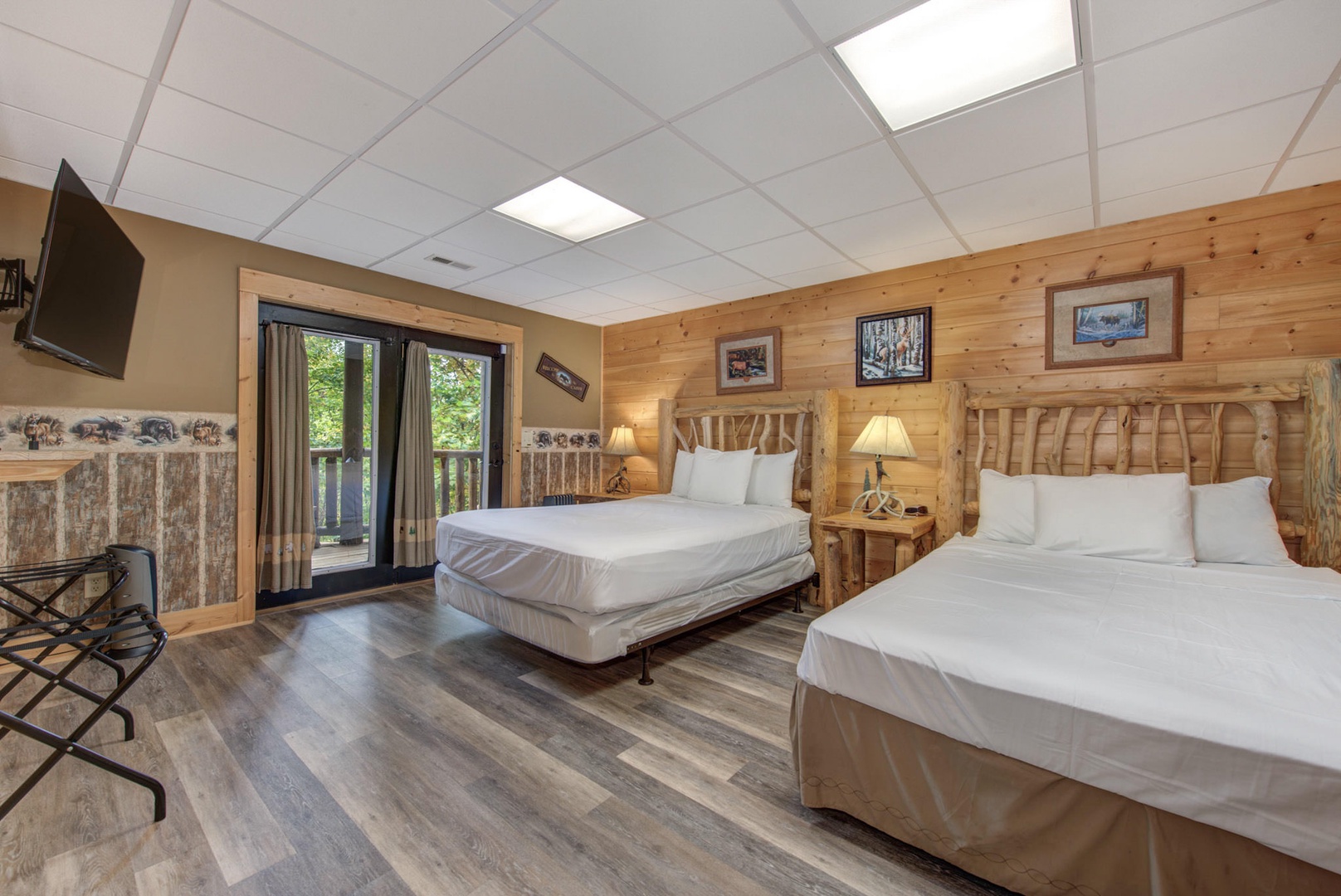 Bedroom 6 with 2 Queen beds, Smart TV, deck access, and private en-suite