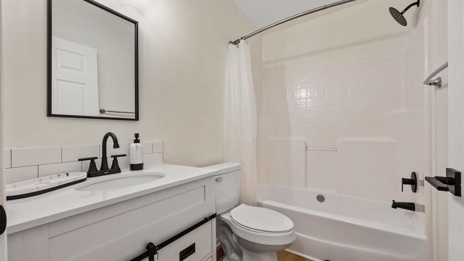 The shared full bathroom includes a single vanity & shower/tub combo