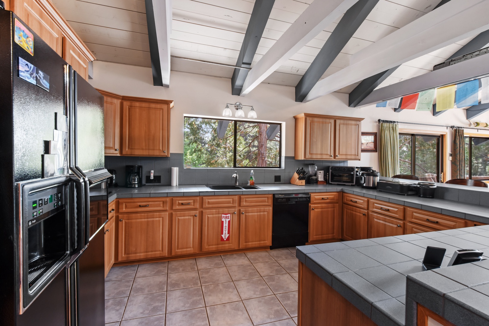 Kitchen with drip coffee maker, toaster oven, blender, slow cooker, and more