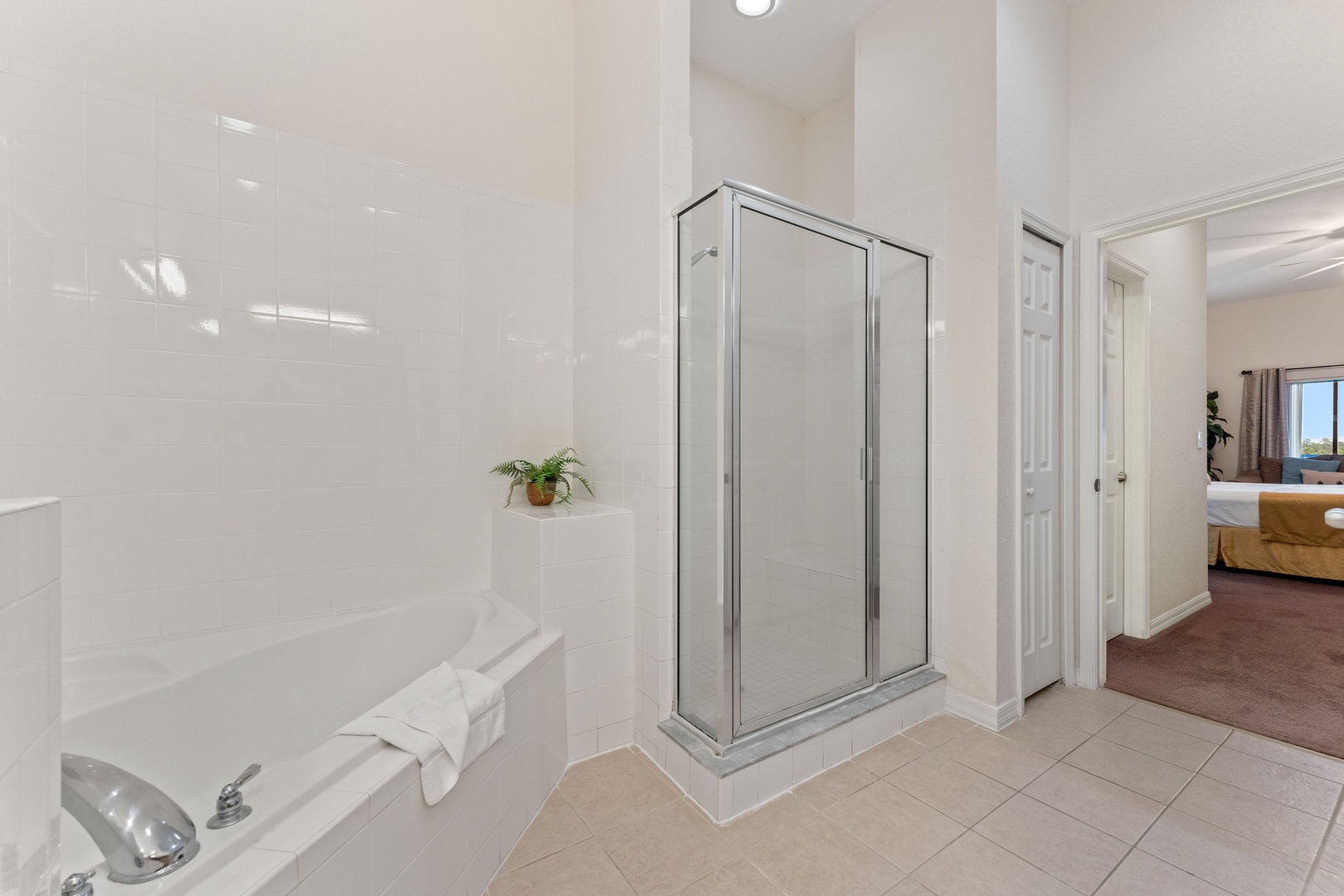 A double vanity, shower, & tub await in the ensuite bath