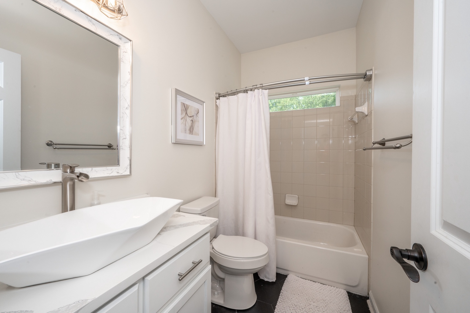 The 2nd floor full bath offers a stylish vanity & shower/tub combo