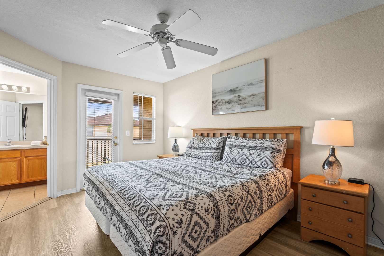 King bedroom with private ensuite, private balcony access and ceiling fan