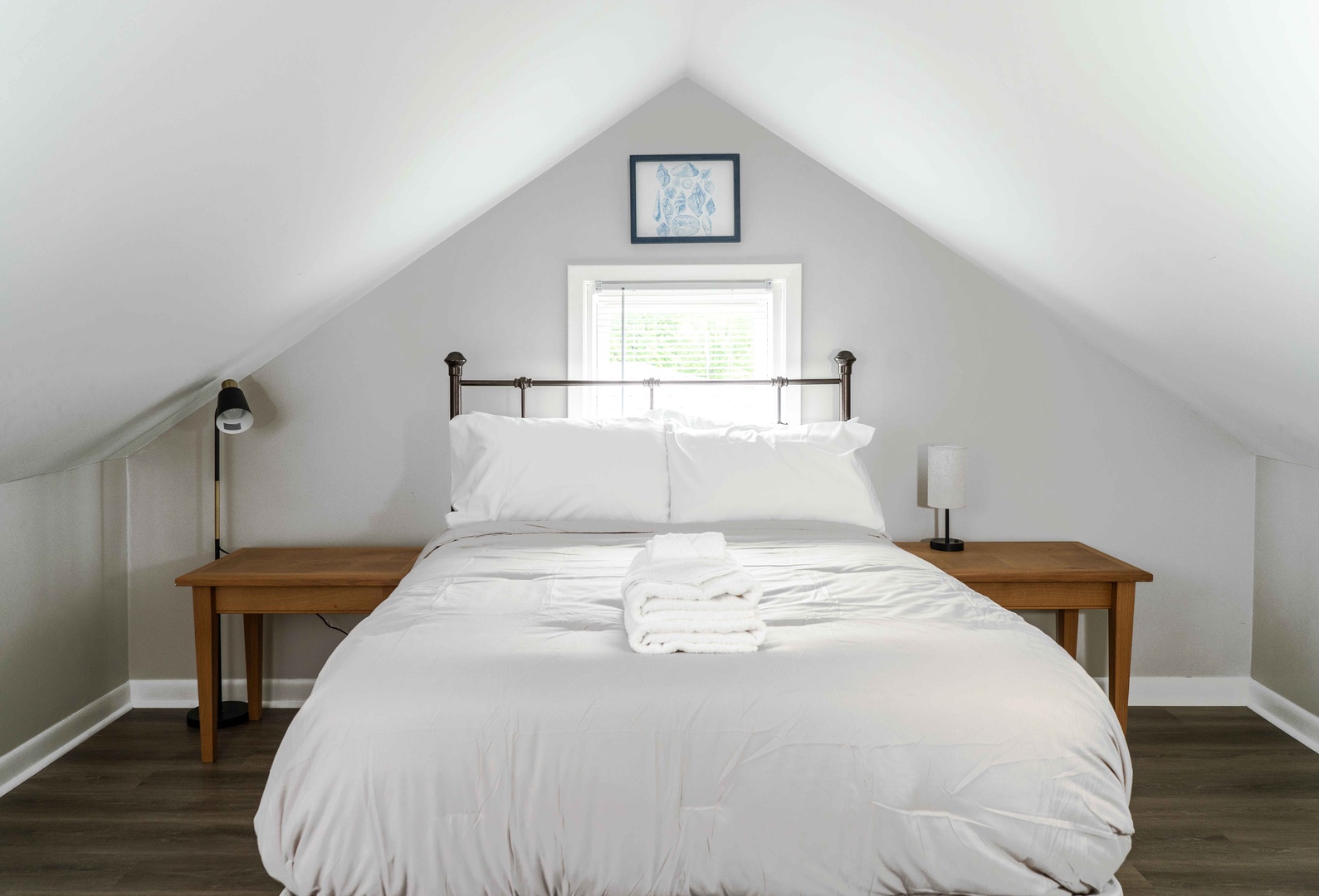 The serene 2nd-floor bedroom boasts a pair of full-sized beds & smart TV