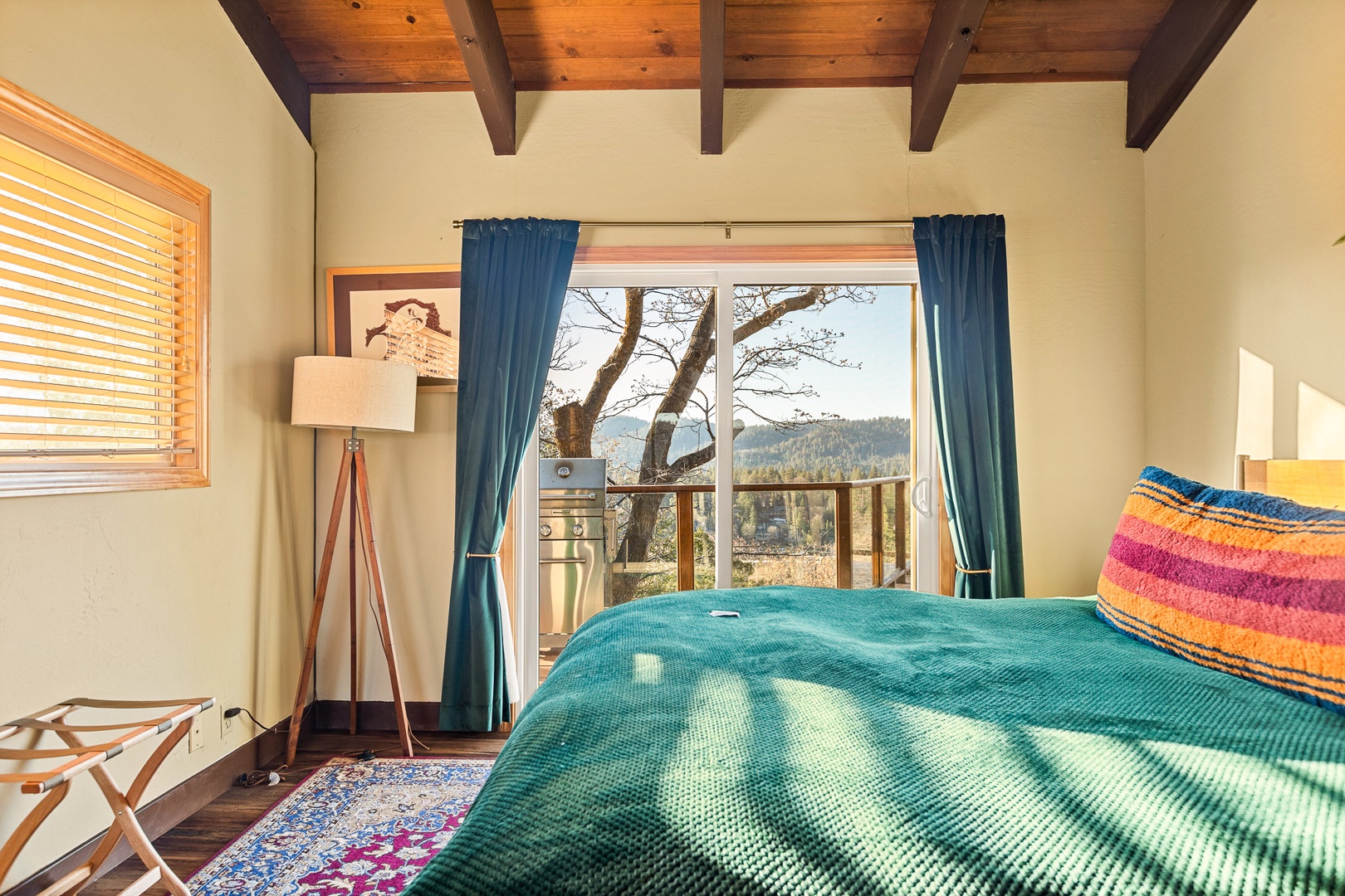 Retreat to this King Bedroom with luxe bedding and splendid views from the back deck