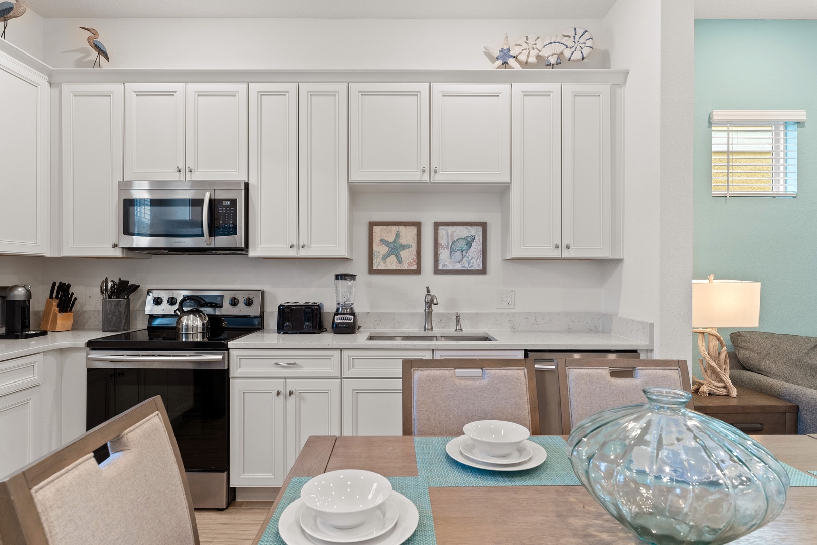 The beachy eat-in kitchen offers ample space & all the comforts of home