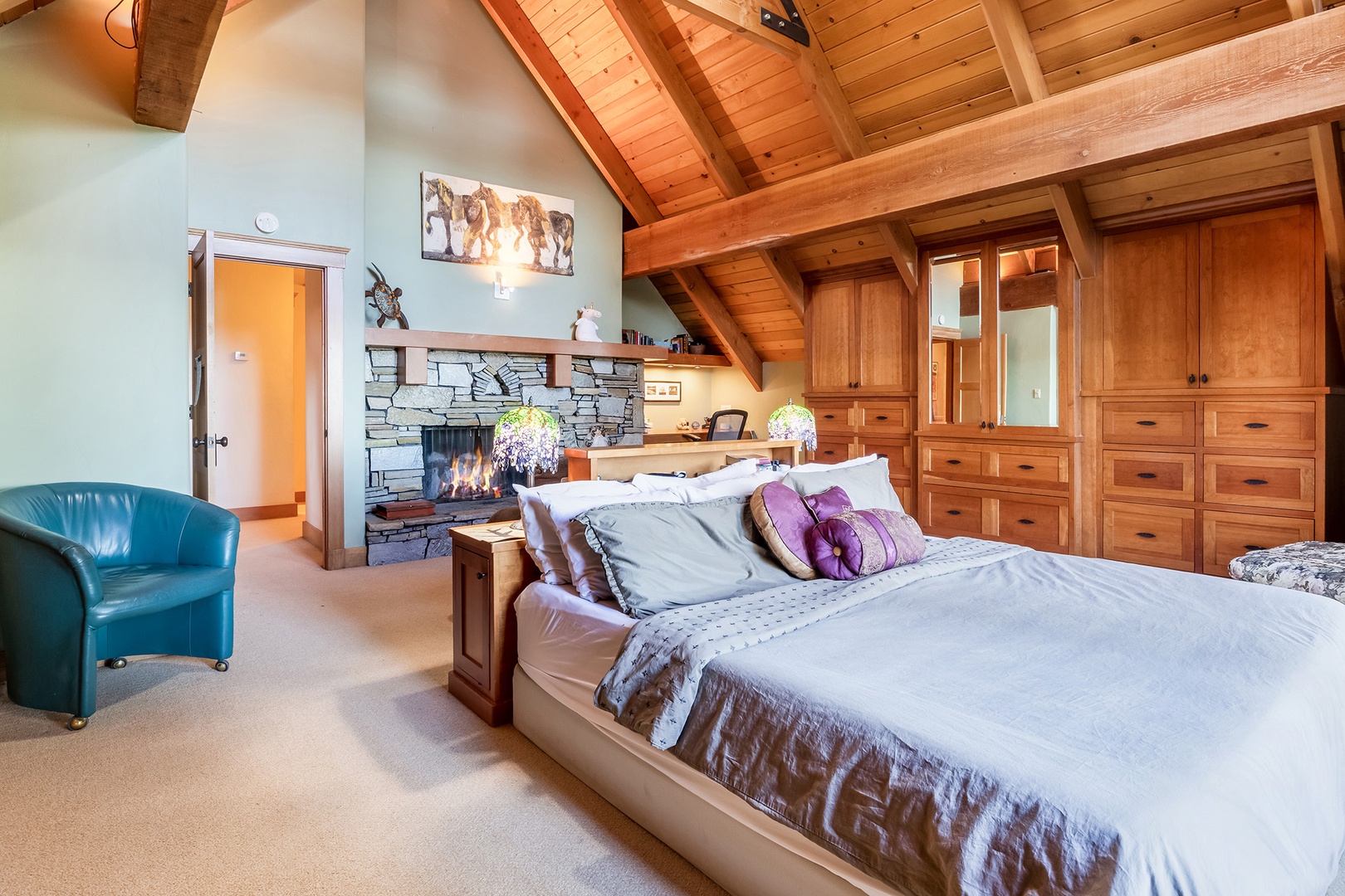 The 3rd floor king bedroom features glass patio doors, balcony access, and dramatic lake views