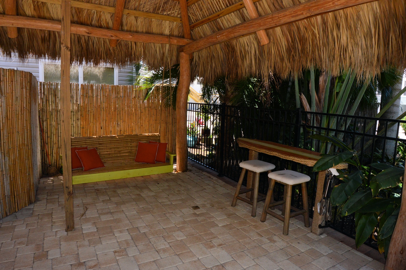 Tropical patio with outdoor seating and BBQ