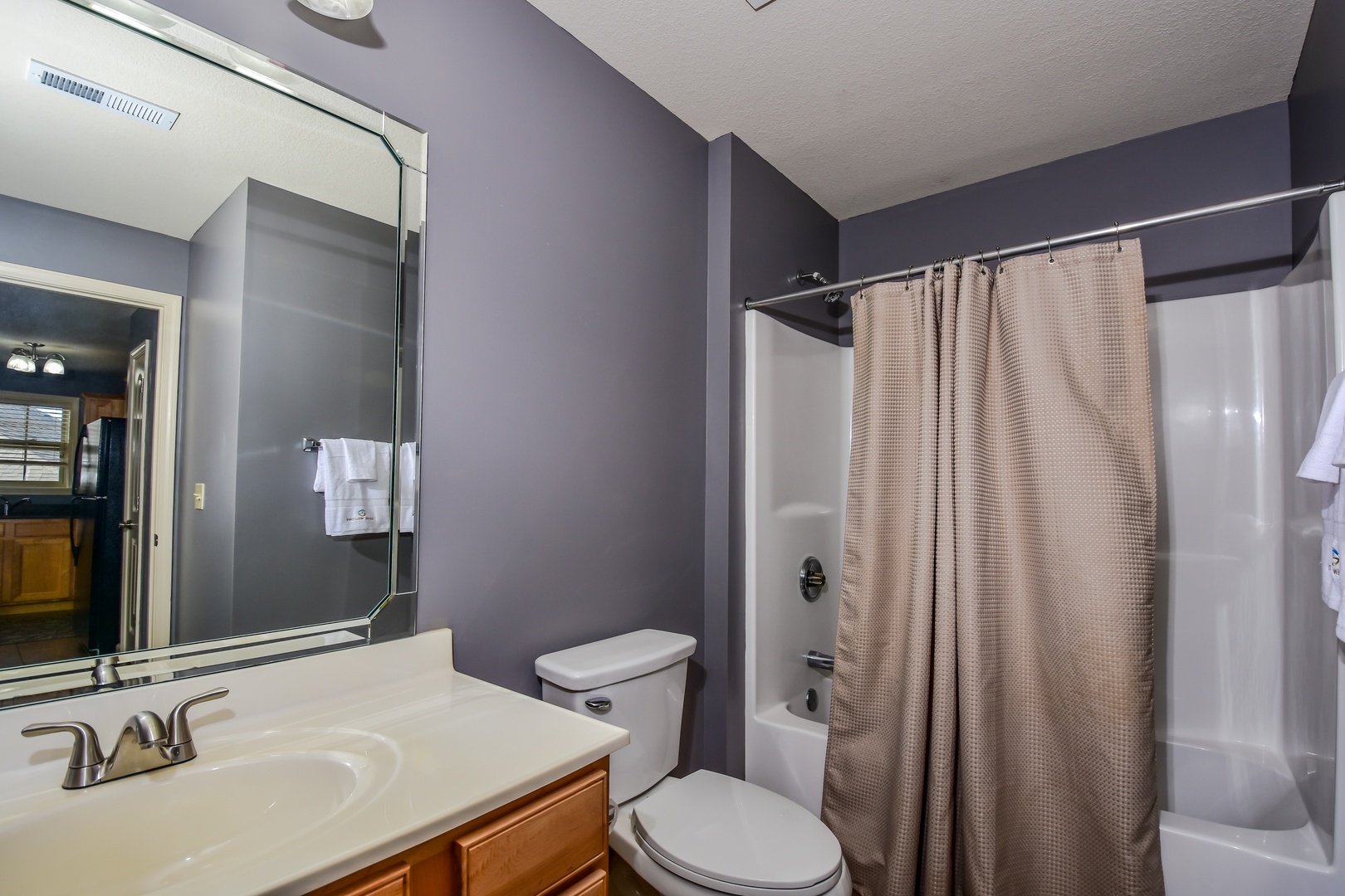 The shared full bath features a single vanity & shower/tub combo
