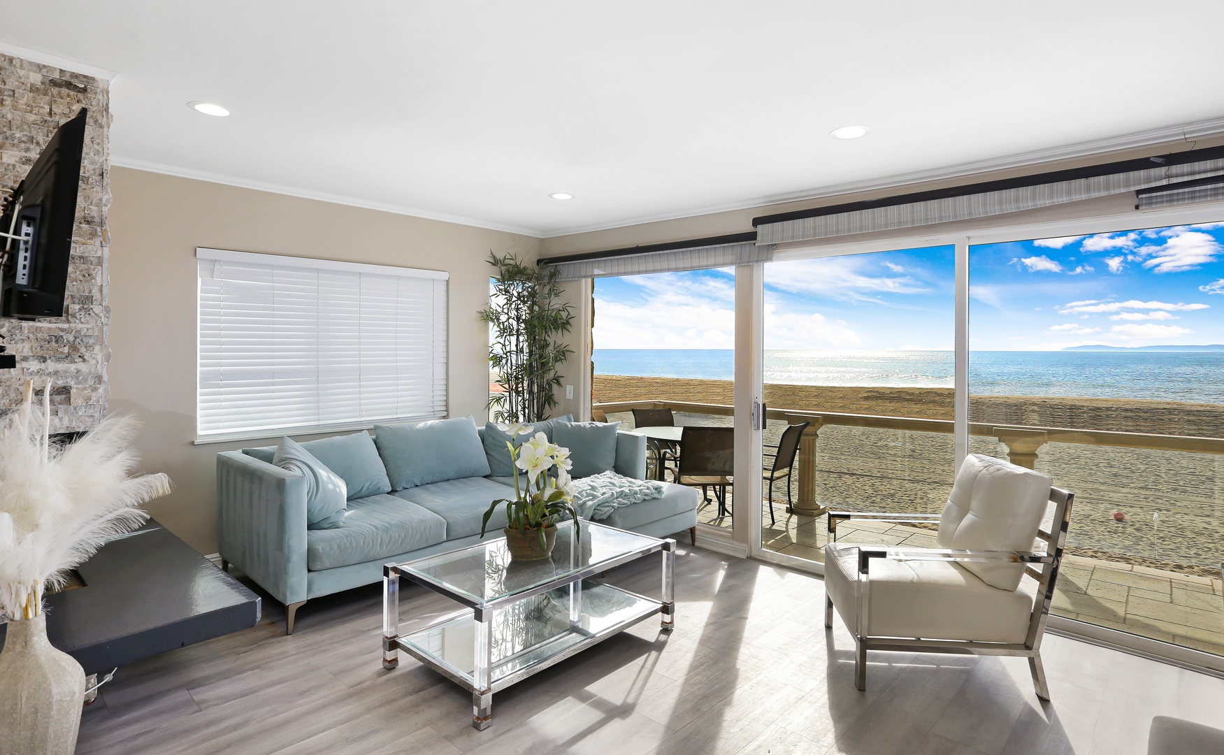 Beach view living room with flat screen TV