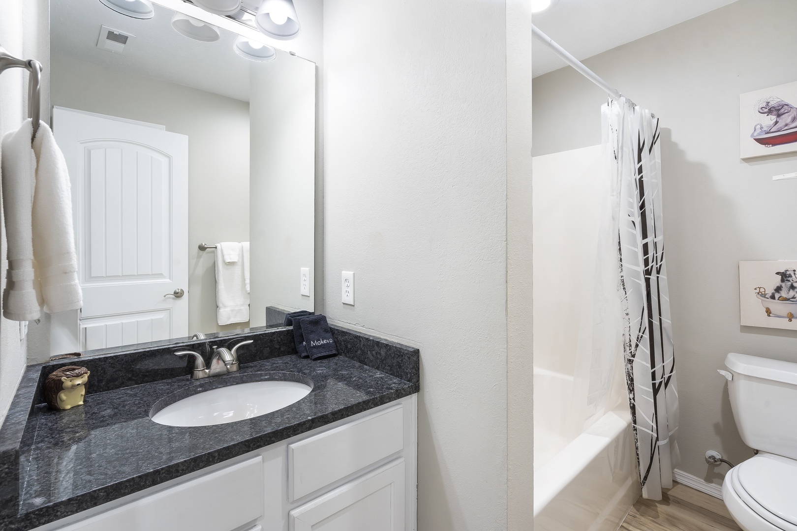 The shared full bathroom showcases a single vanity & shower/tub combo