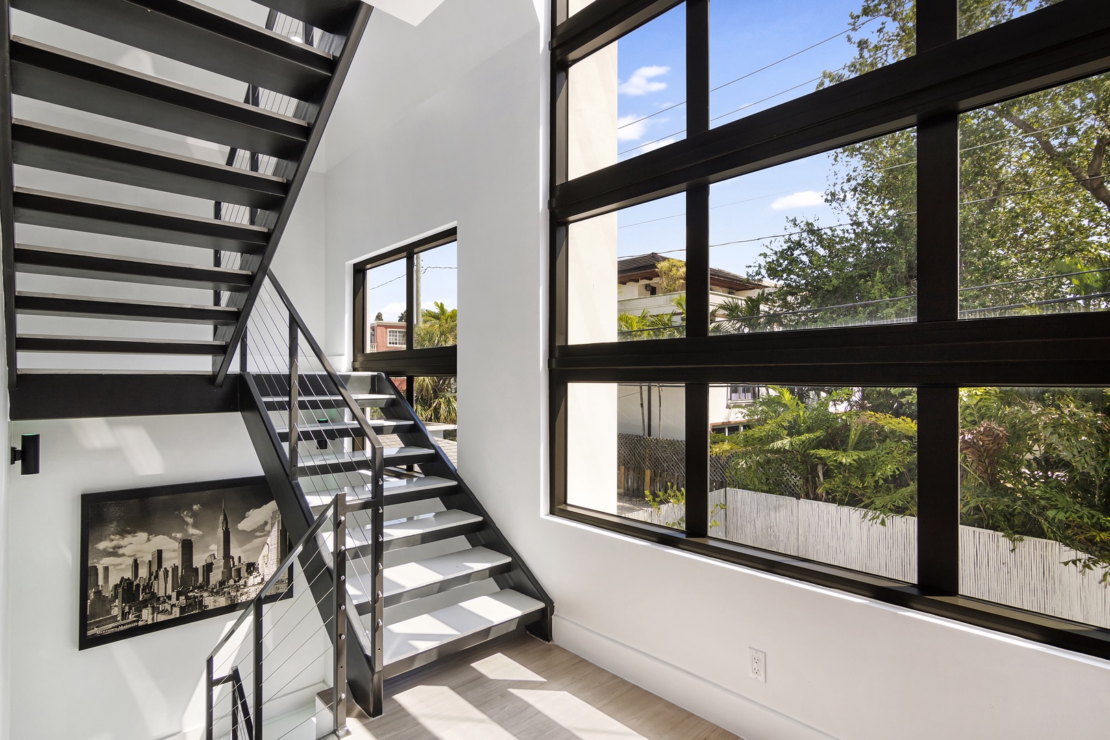 Natural light fills the Instagrammable staircase, leading to the 3rd floor