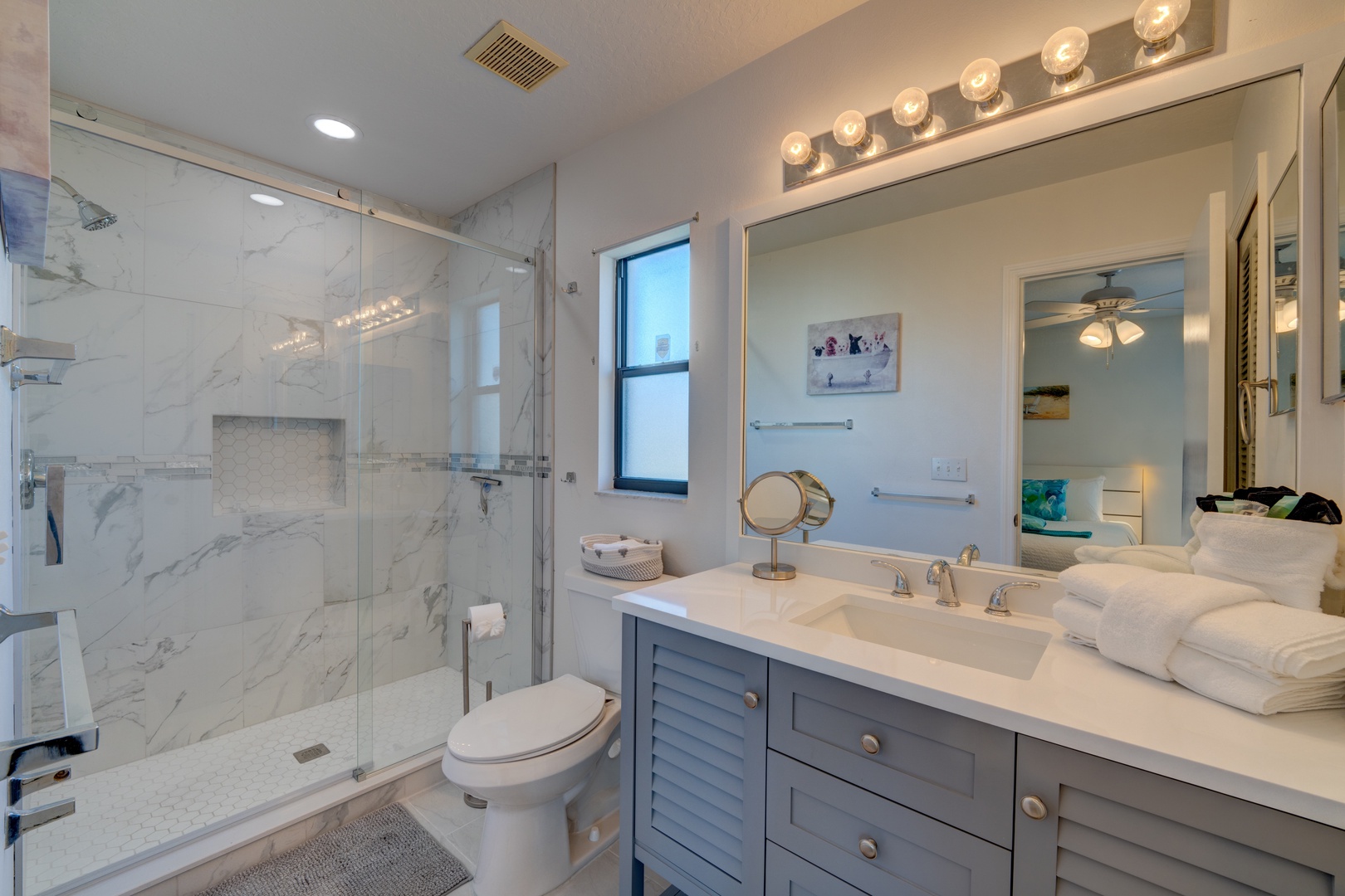 Wash up in this elegant ensuite, featuring a single vanity & walk-in shower