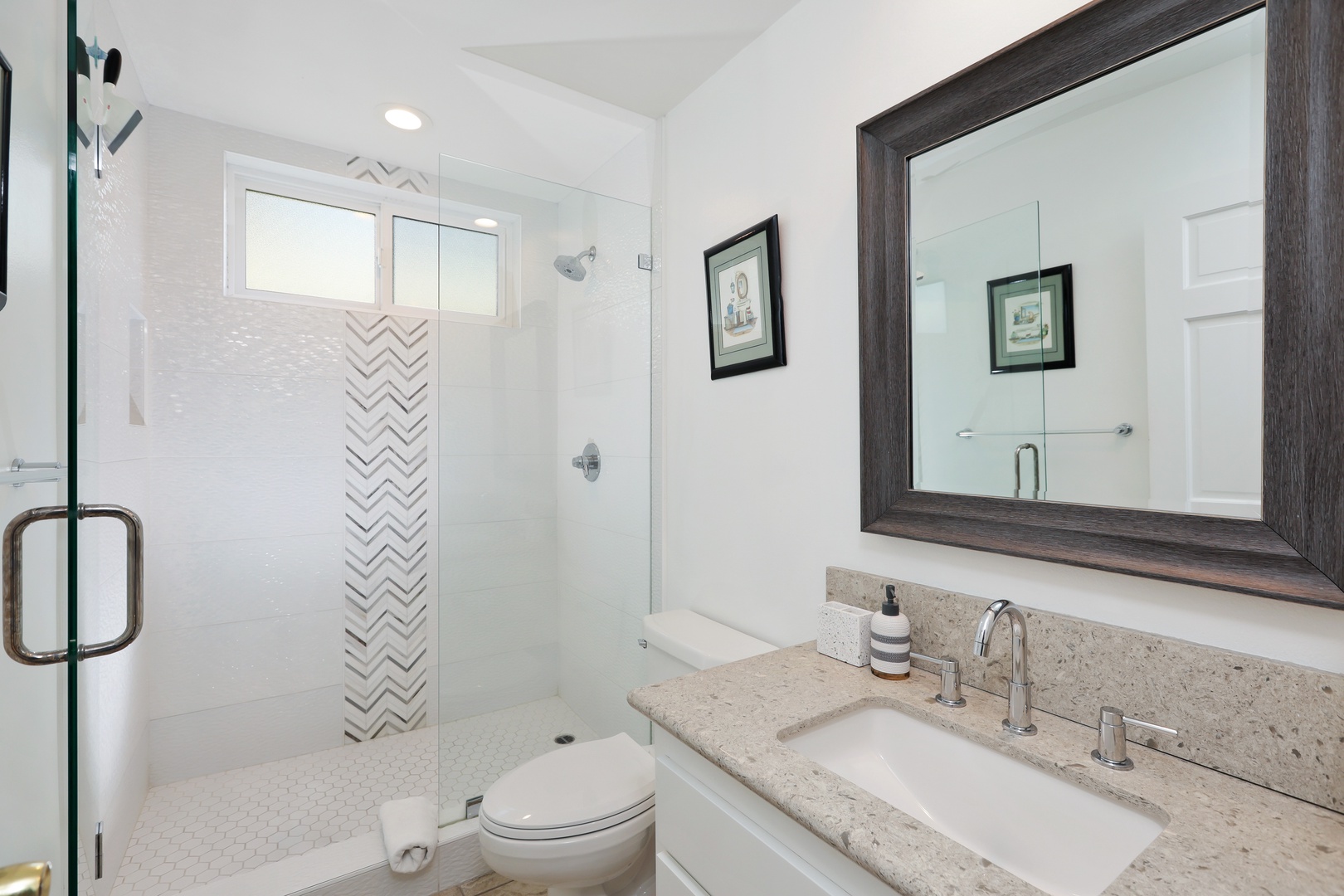 Wash up in the queen ensuite, featuring a single vanity & glass shower