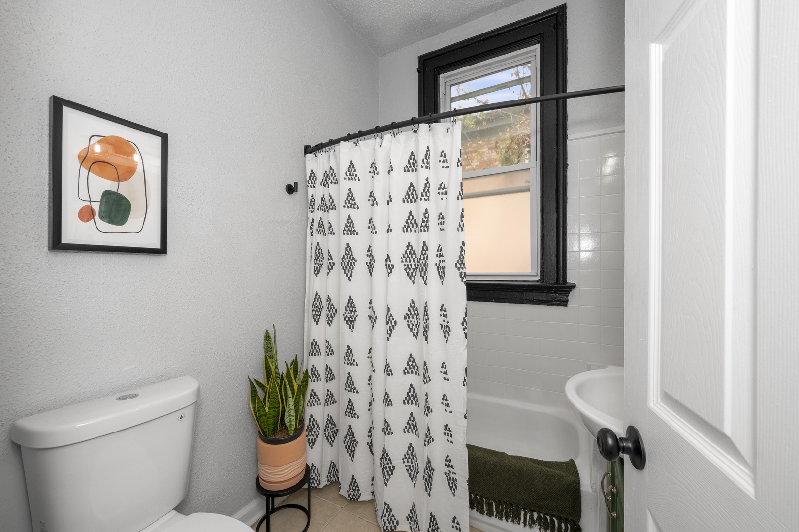 Get ready in this full bath, offering a single vanity & shower/tub combo