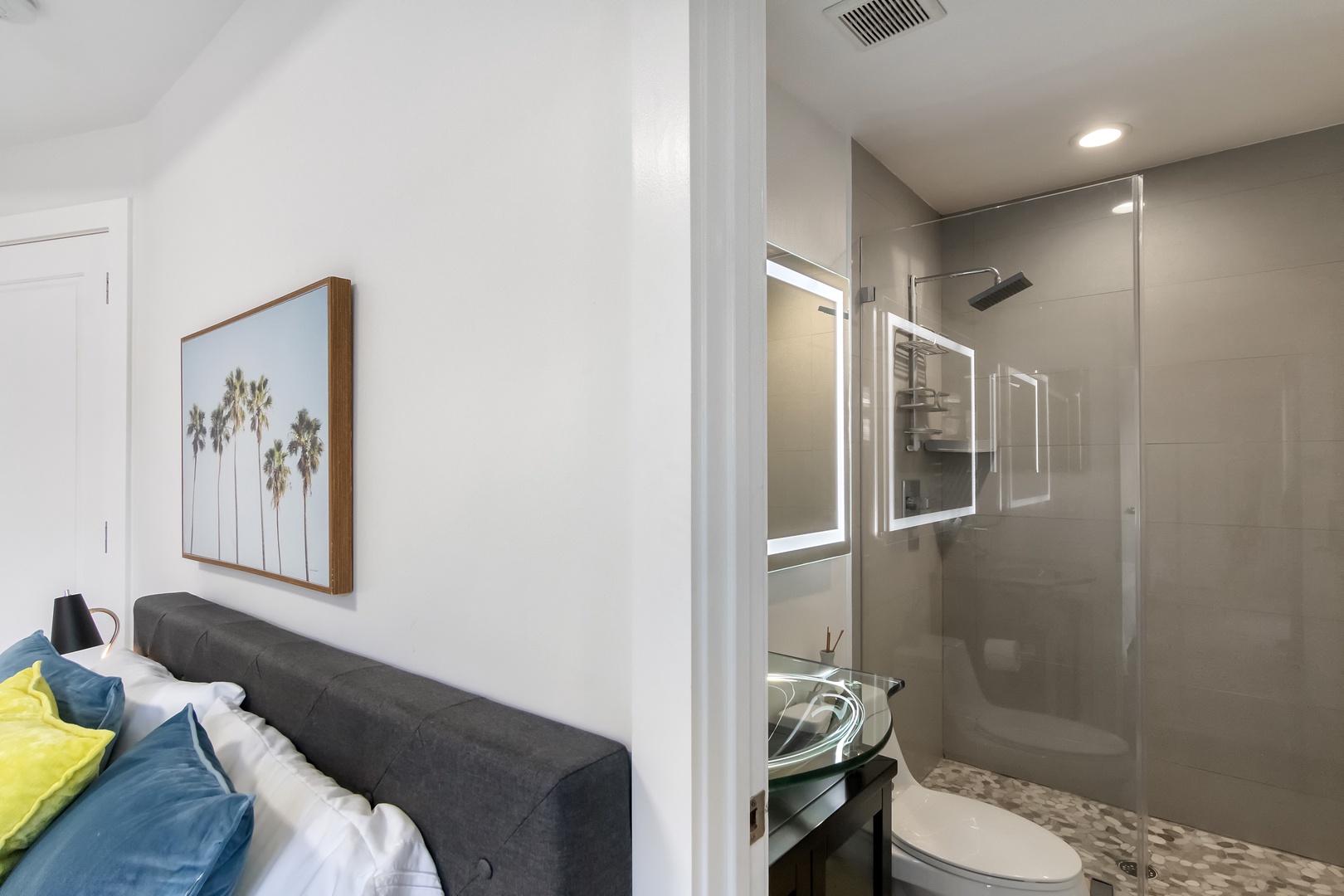 This ensuite bath showcases a sleek single vanity & spa-like glass shower