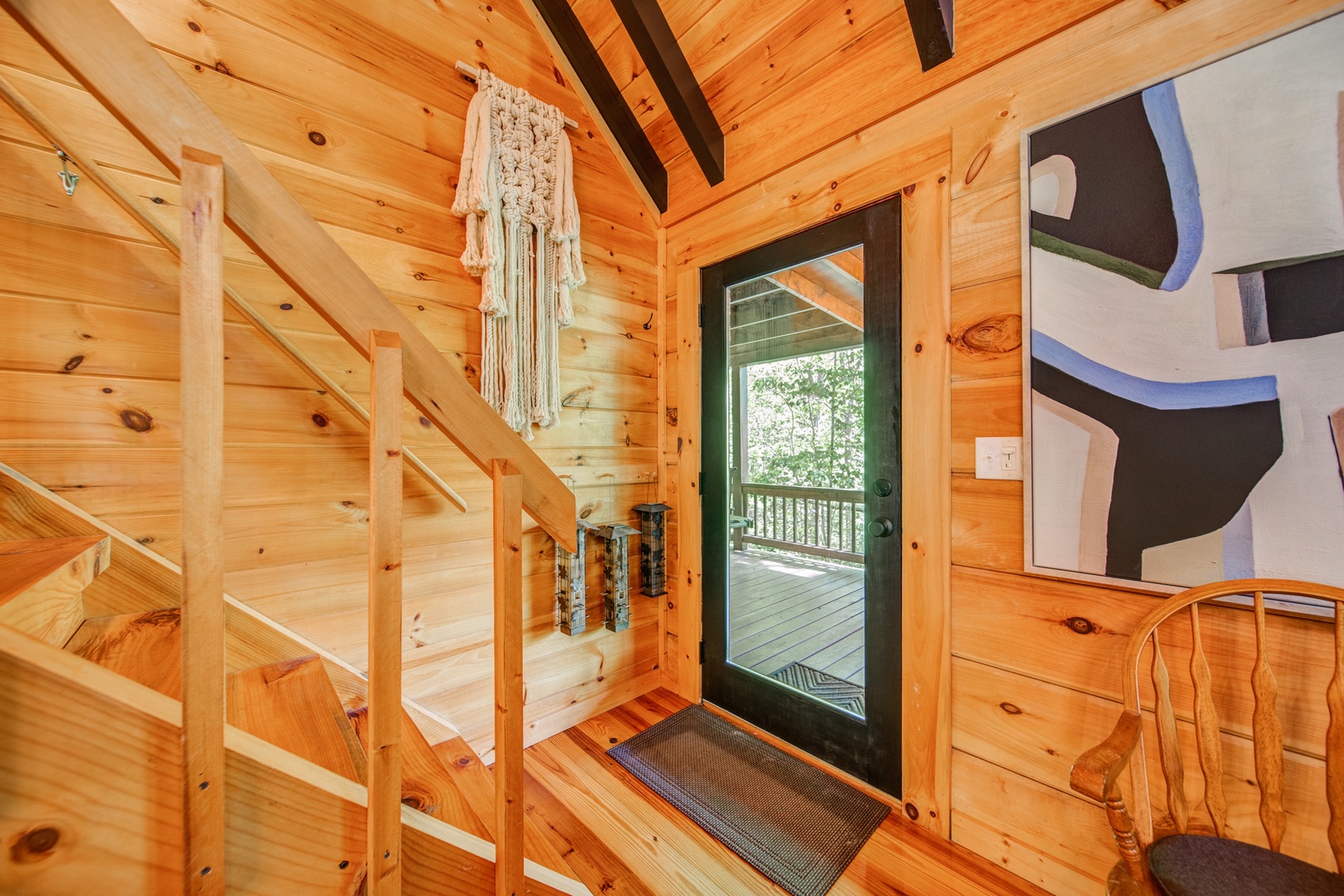 Door to the main level deck with grilling and seating for entertaining your guests