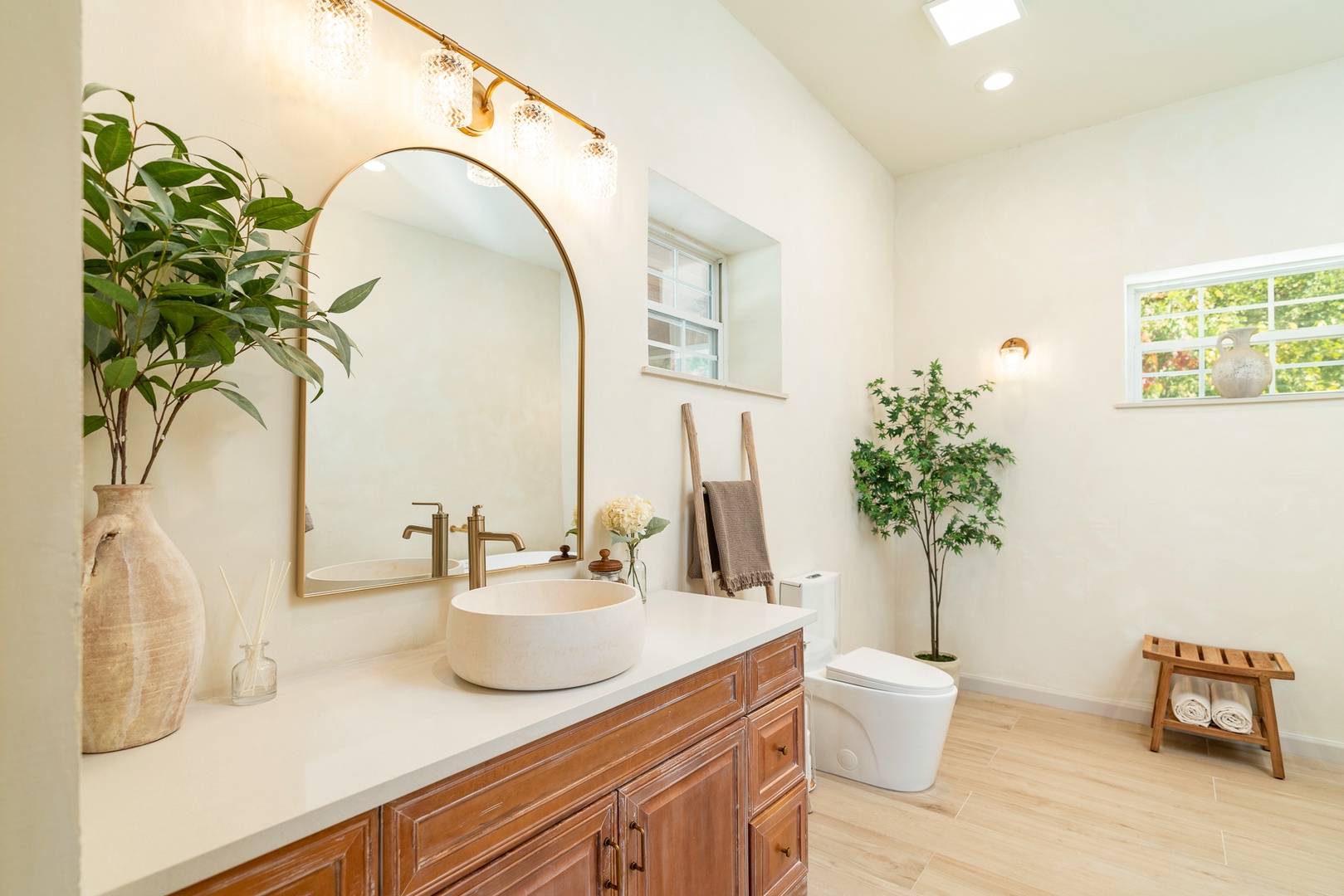 A chic vanity, shower, & luxurious soaking tub await in this ensuite bath