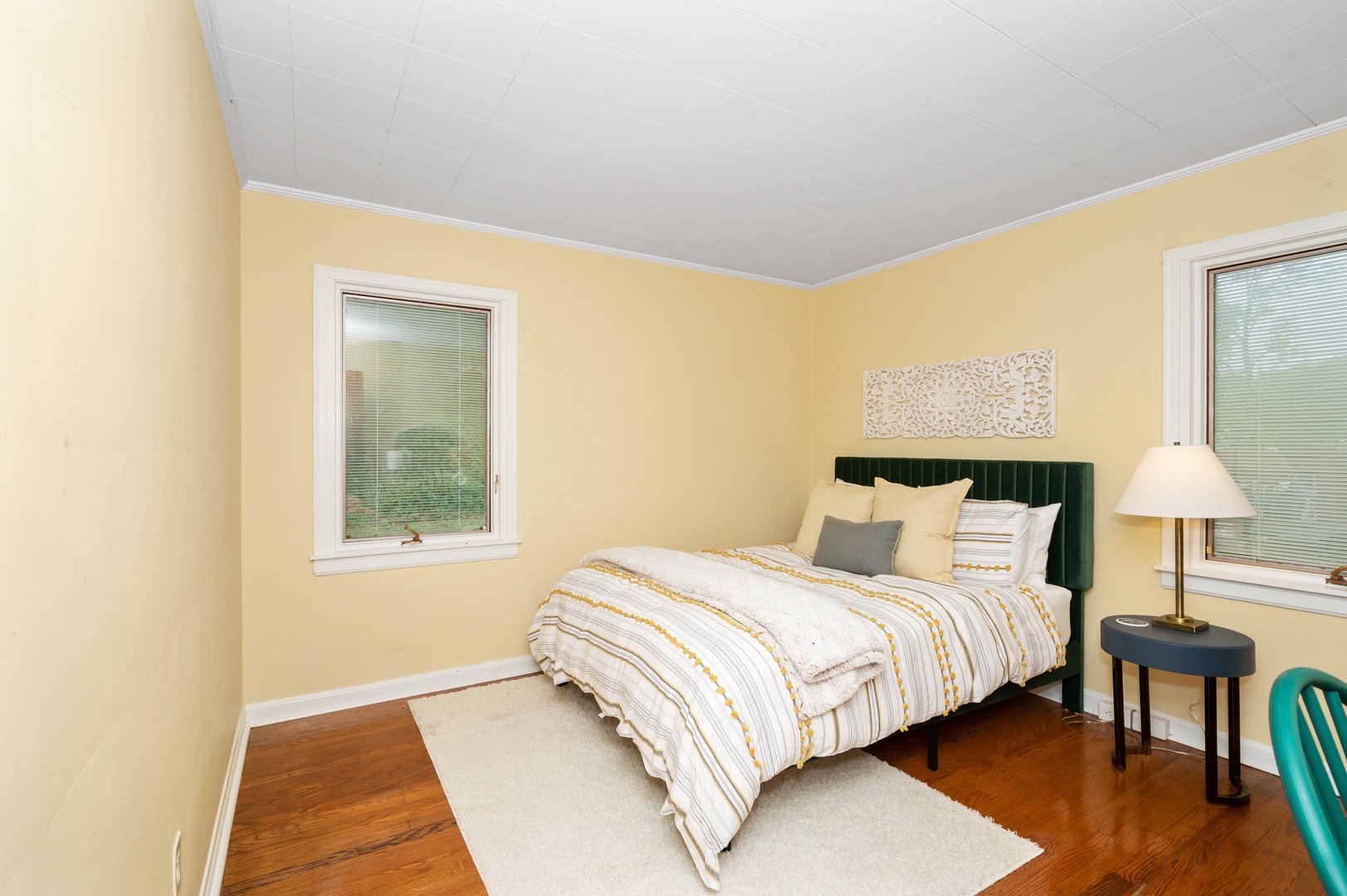 The spacious first-floor bedroom offers a queen bed & desk workspace