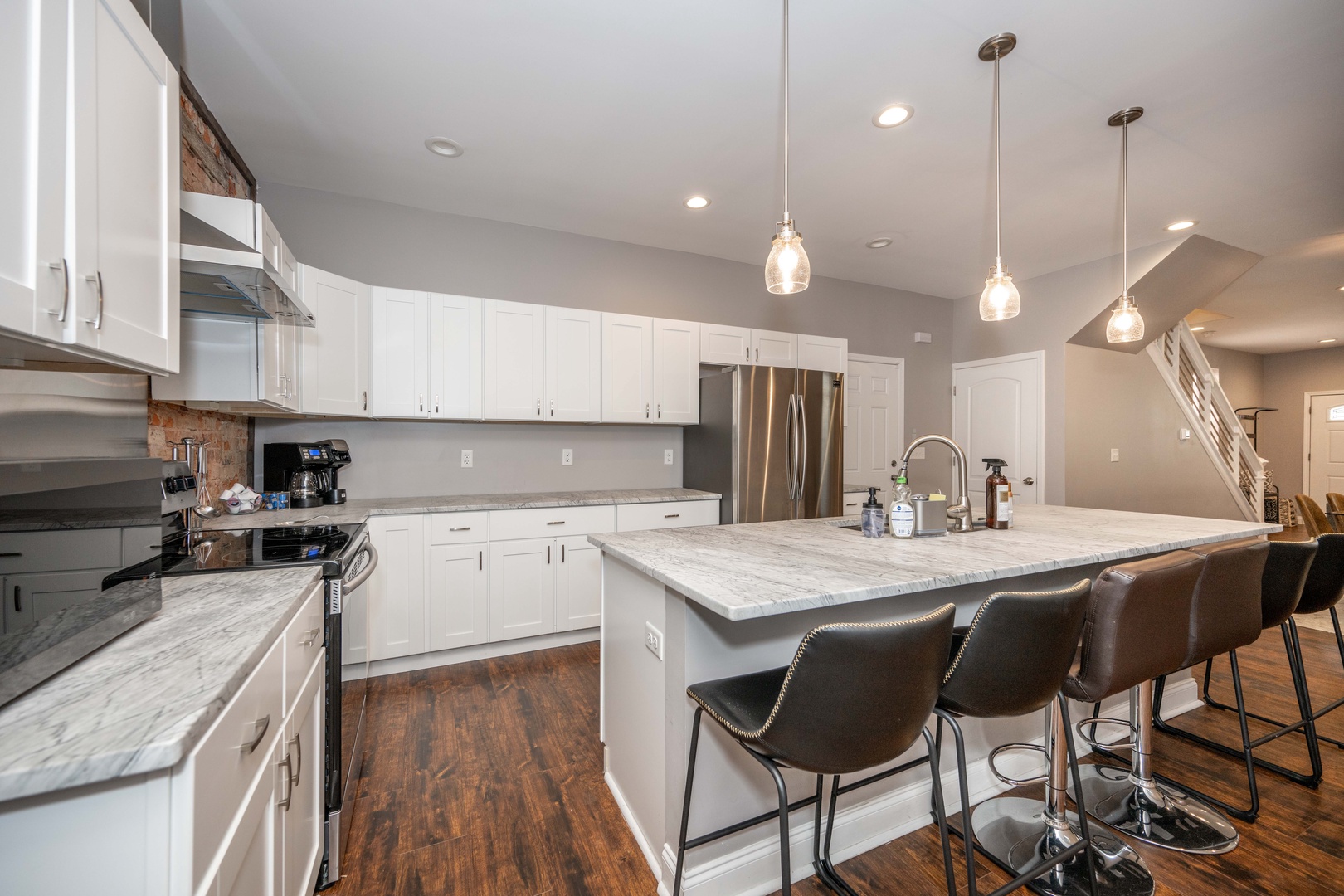 The chic, updated kitchen offers ample space & every home comfort