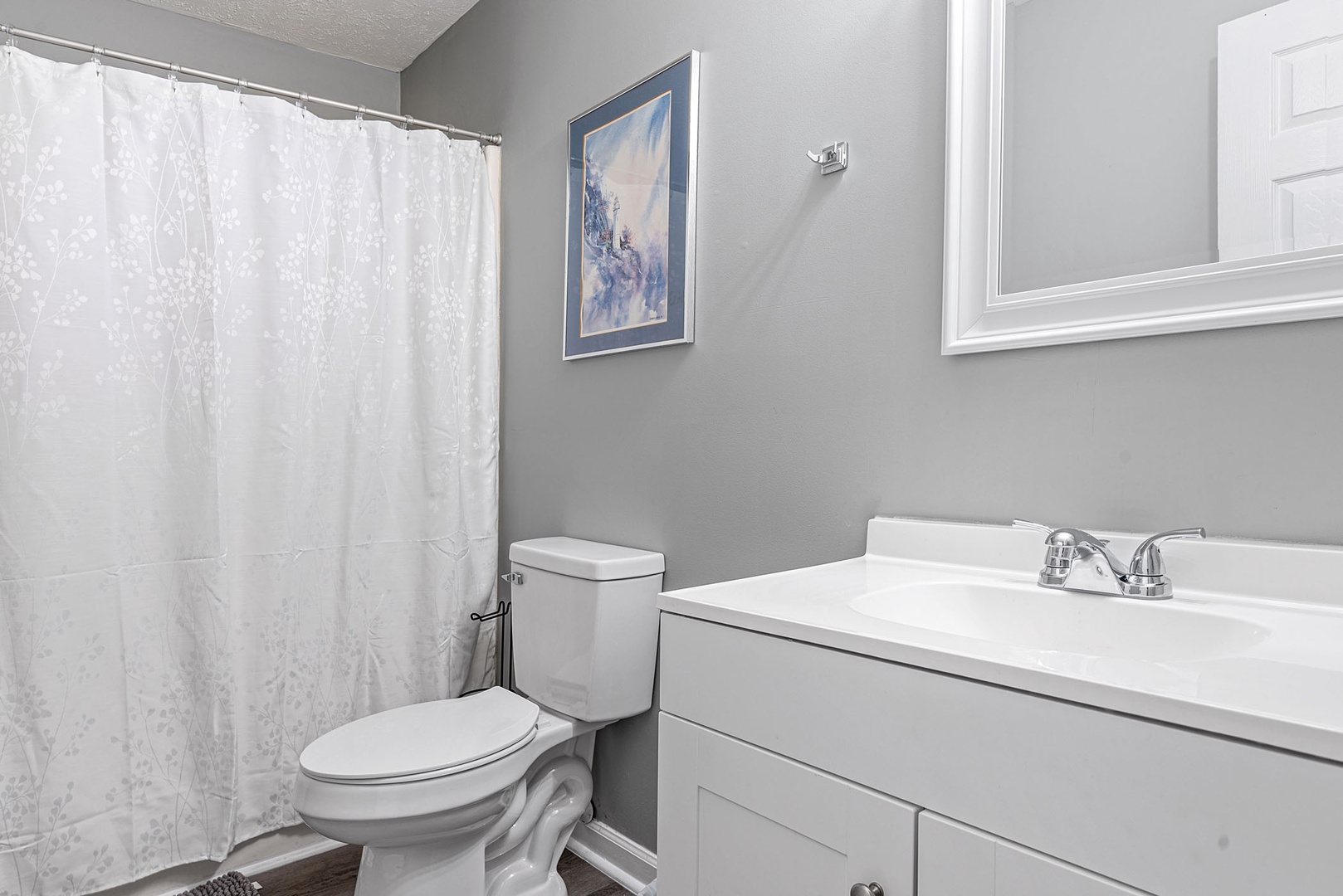 This home's full bathroom offers a single vanity & showertub combo