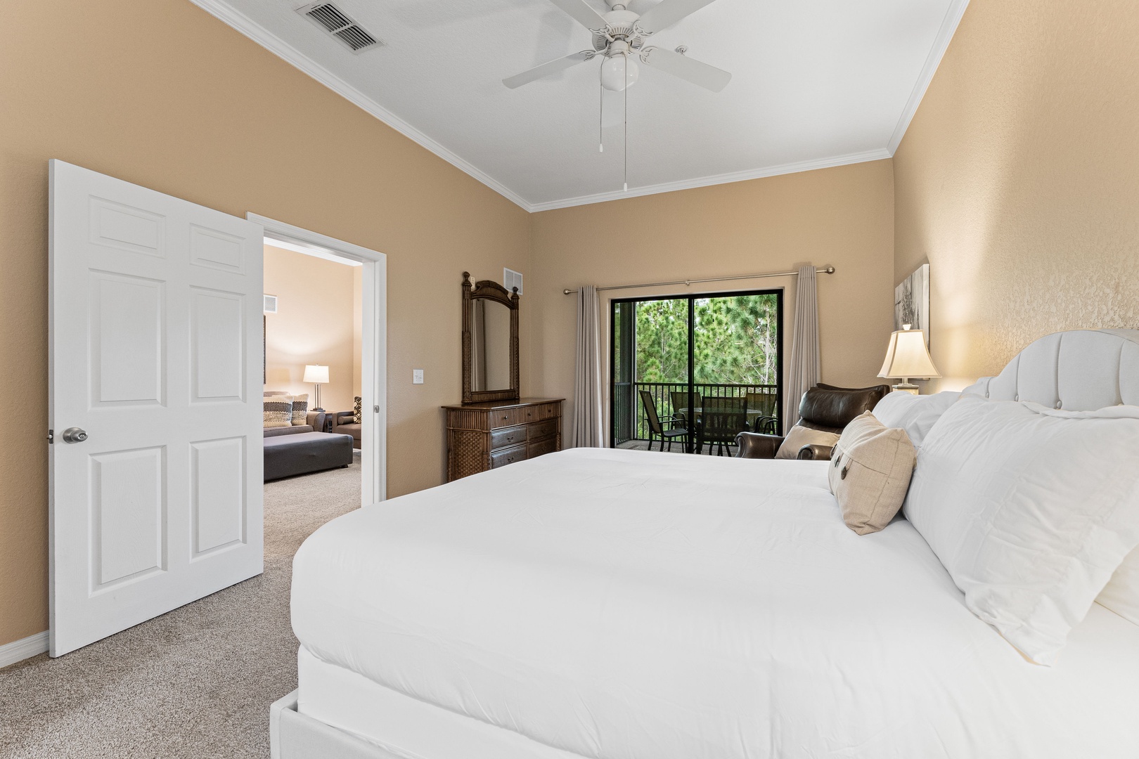 The primary king suite boasts an ensuite bath, TV, & balcony access