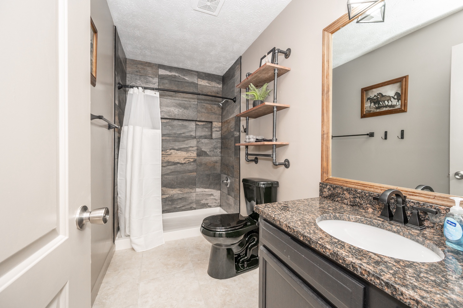 Apartment 2’s stylish full bathroom includes a single vanity & walk-in shower