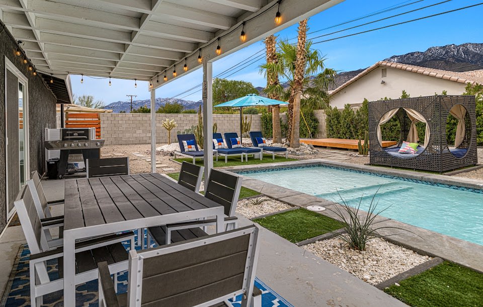 Outdoor dining and lounge chairs by the pool
