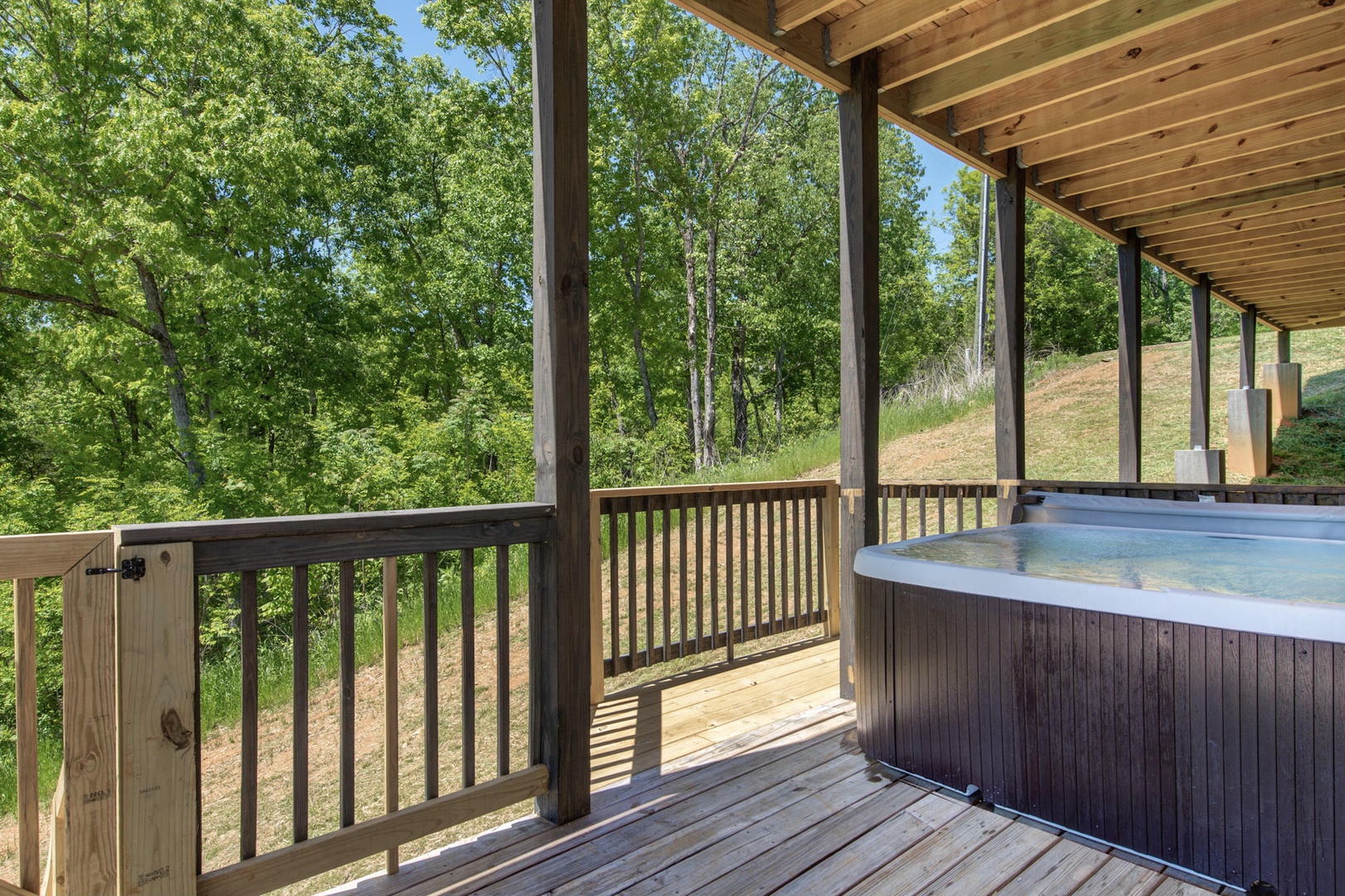 Covered hot tub on bottom deck
