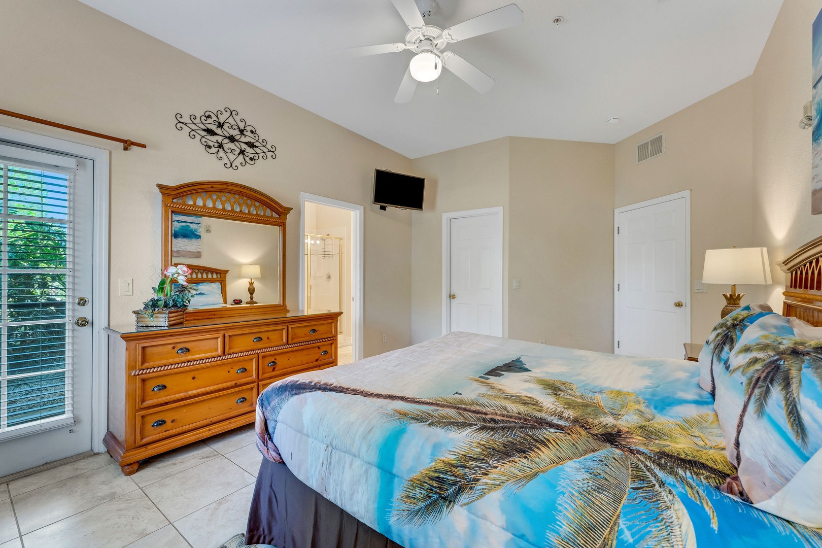 This spacious king suite boasts a private ensuite, TV, & patio access
