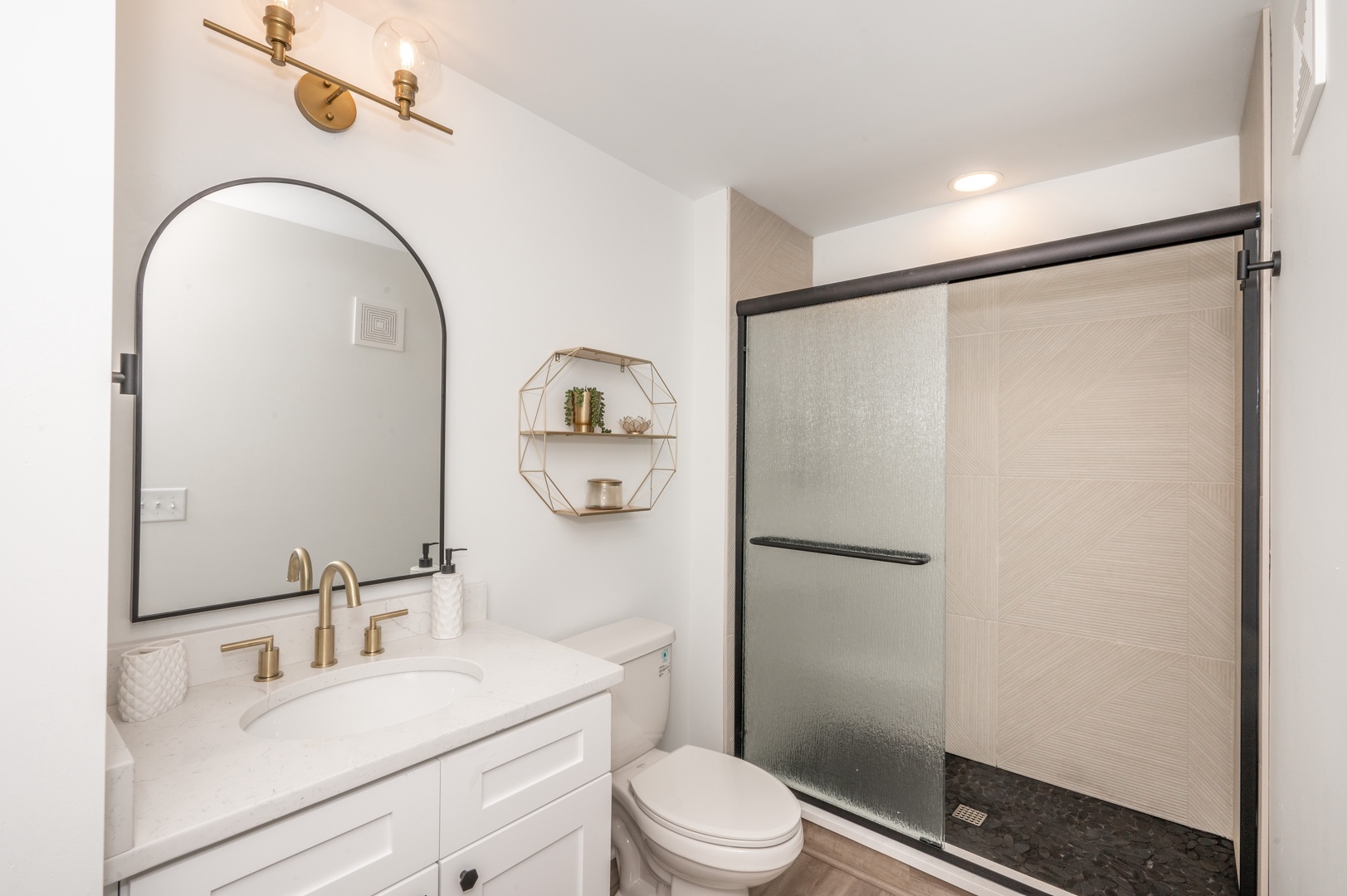 Unit 101: The chic bathroom offers a single vanity and spa-like glass shower