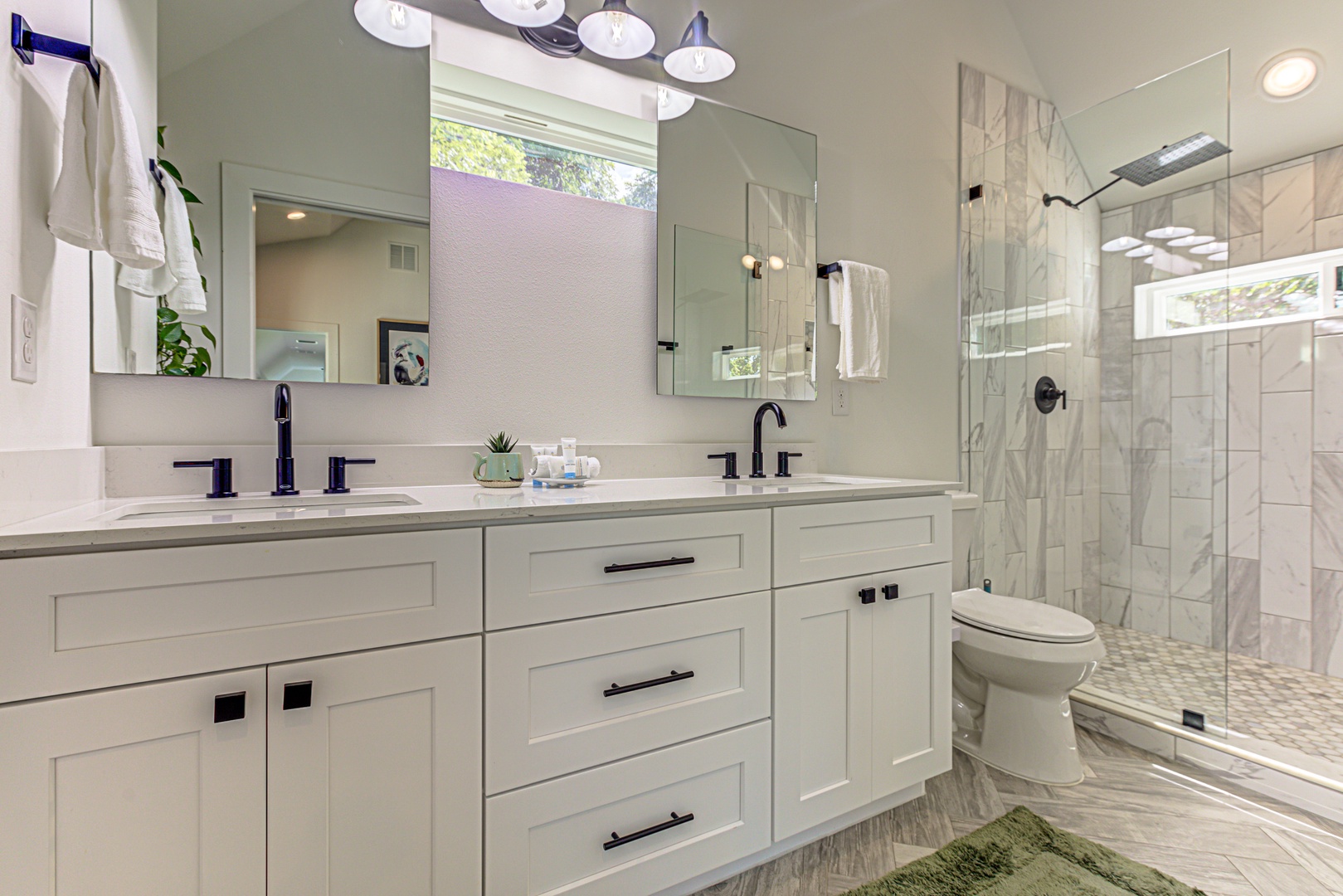 Ensuite bathroom with dual sinks and stand-up shower